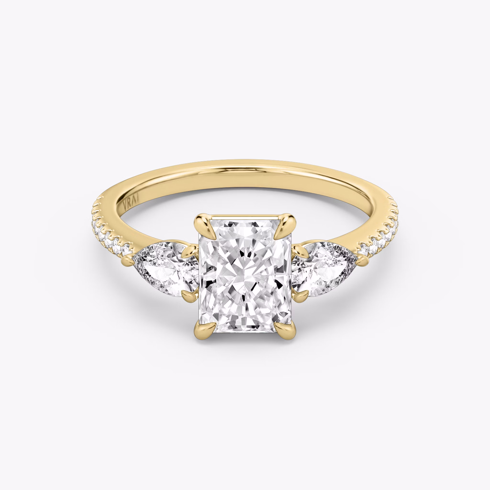 The Three Stone | Radiant | 18k | Yellow Gold | bandAccent: Pavé | sideStoneCarat: 0.25ct | sideStoneShape: Pear | diamondOrientation: vertical | caratWeight: other