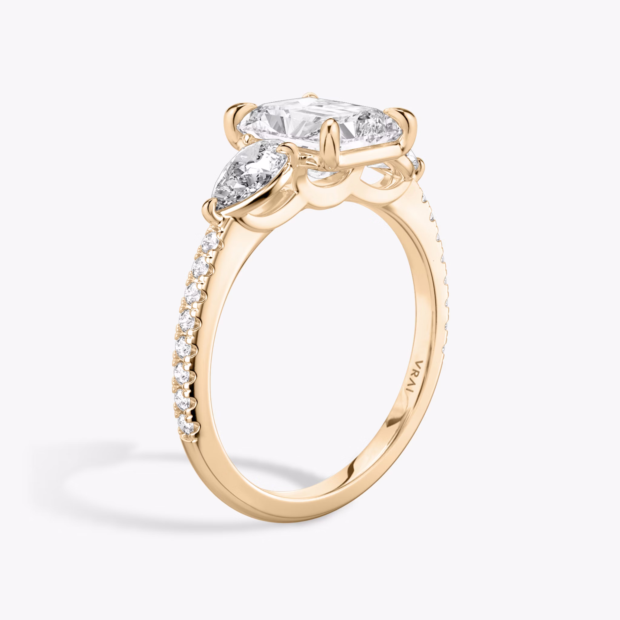 The Three Stone | Radiant | 14k | Rose Gold | bandAccent: Pavé | sideStoneCarat: 0.25ct | sideStoneShape: Pear | diamondOrientation: vertical | caratWeight: other