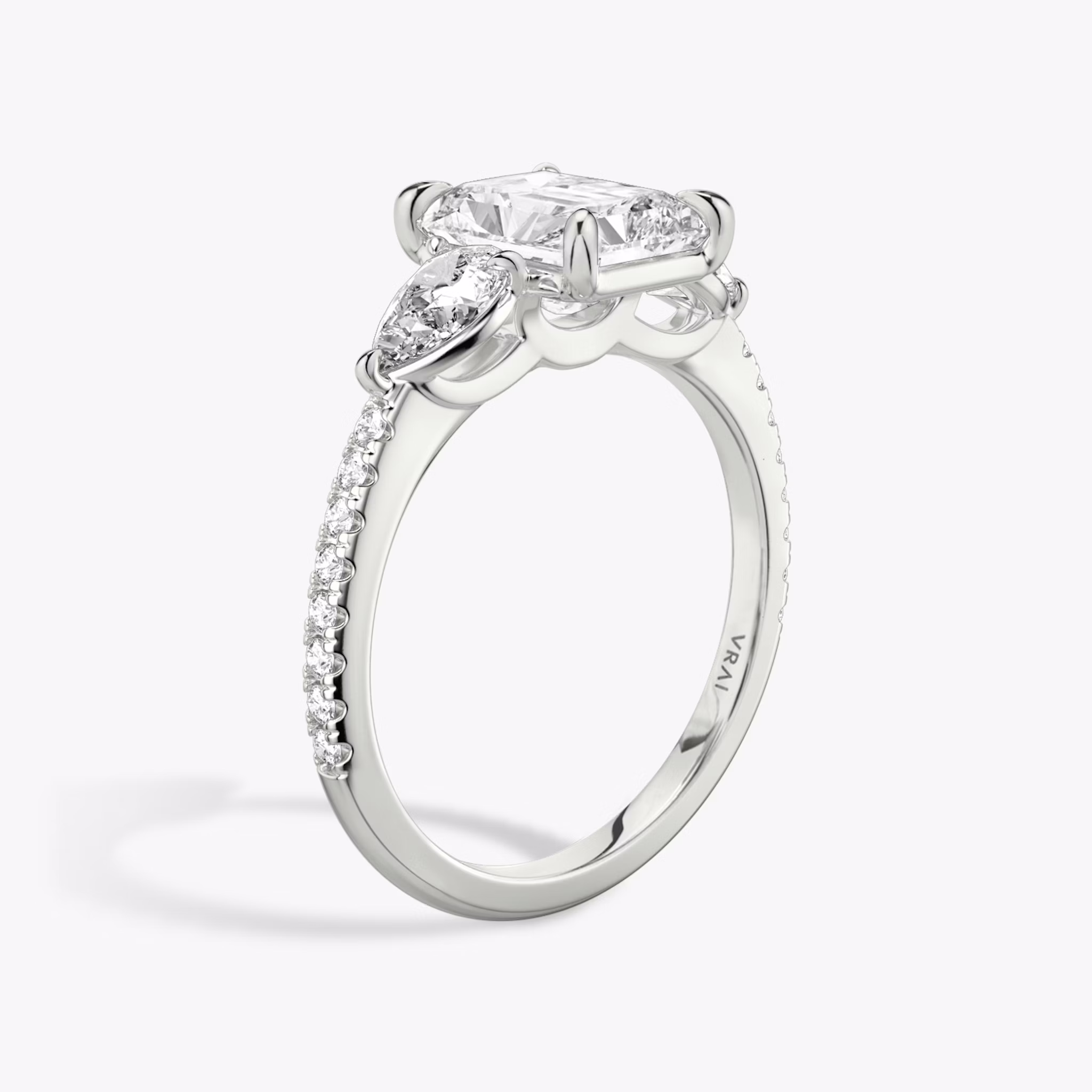 The Three Stone | Radiant | Platinum | bandAccent: Pavé | sideStoneCarat: 0.25ct | sideStoneShape: Pear | diamondOrientation: vertical | caratWeight: other