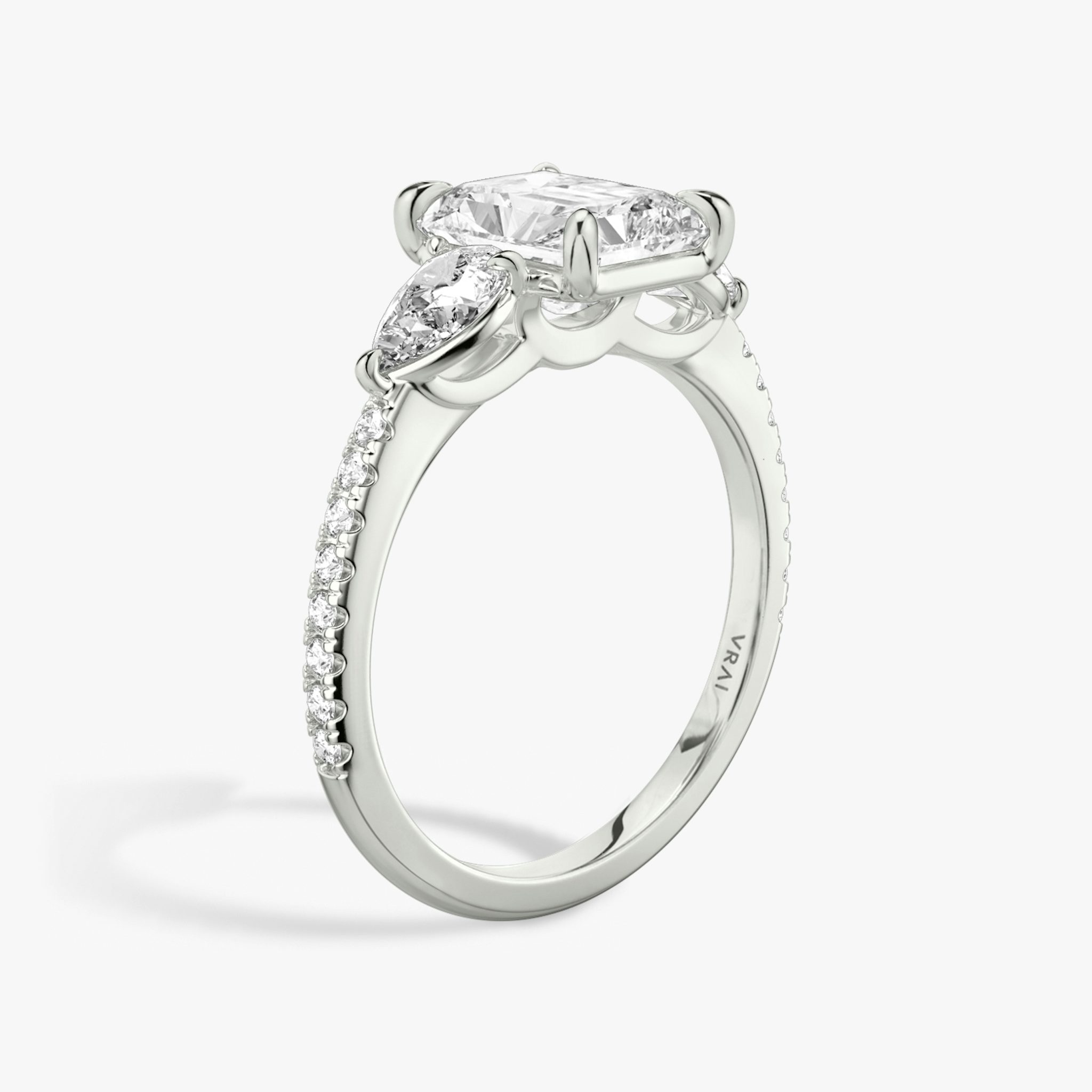 The Three Stone | Radiant | Platinum | bandAccent: Pavé | sideStoneCarat: 0.25ct | sideStoneShape: Pear | diamondOrientation: vertical | caratWeight: other