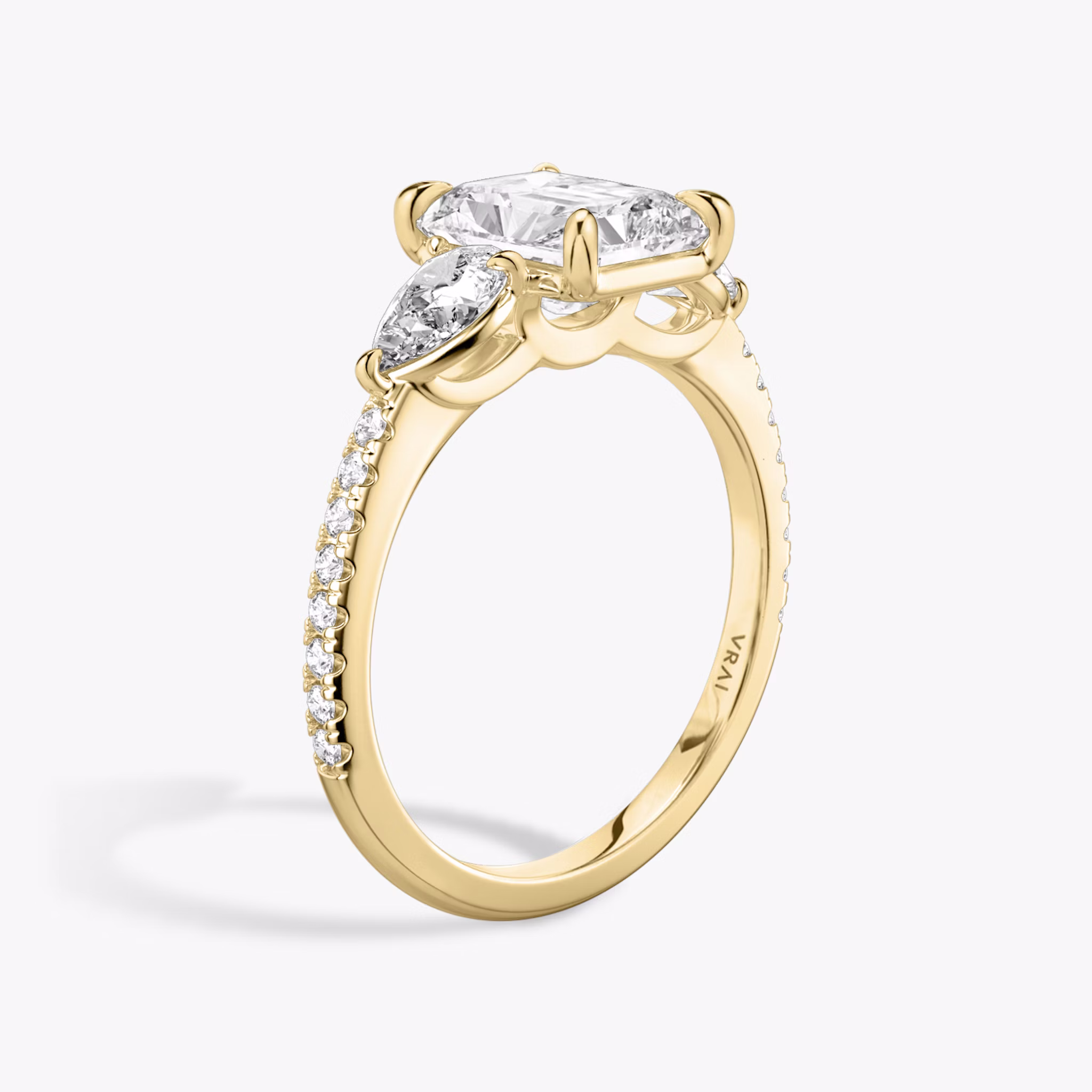 The Three Stone | Radiant | 18k | Yellow Gold | bandAccent: Pavé | sideStoneCarat: 0.25ct | sideStoneShape: Pear | diamondOrientation: vertical | caratWeight: other