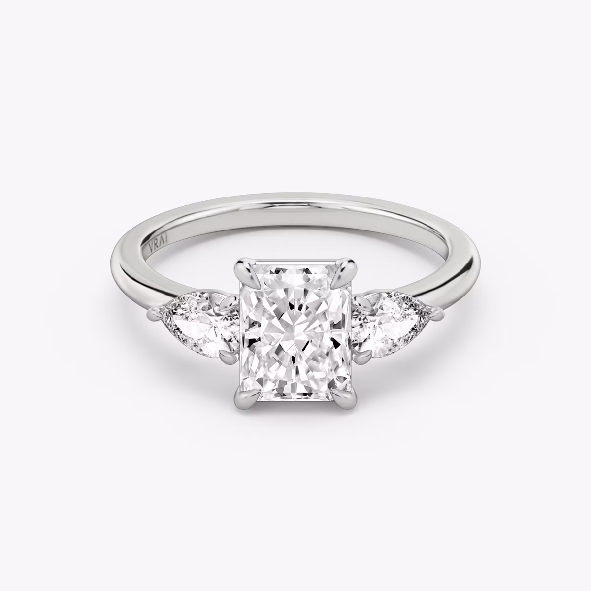 The Three Stone | Radiant | Platinum | bandAccent: Plain | sideStoneCarat: 0.25ct | sideStoneShape: Pear | diamondOrientation: vertical | caratWeight: other