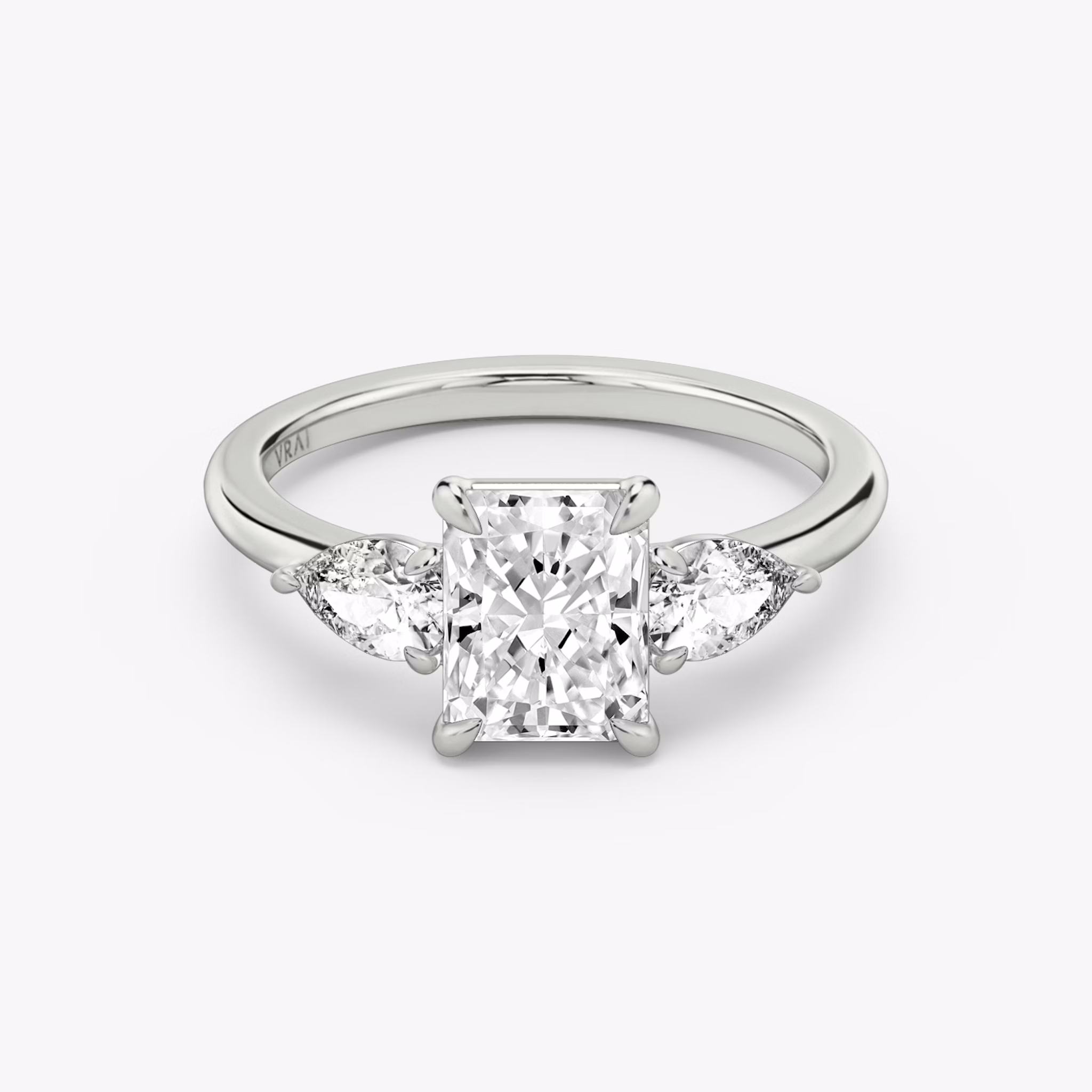 The Three Stone | Radiant | 18k | White Gold | bandAccent: Plain | sideStoneCarat: 0.25ct | sideStoneShape: Pear | diamondOrientation: vertical | caratWeight: other