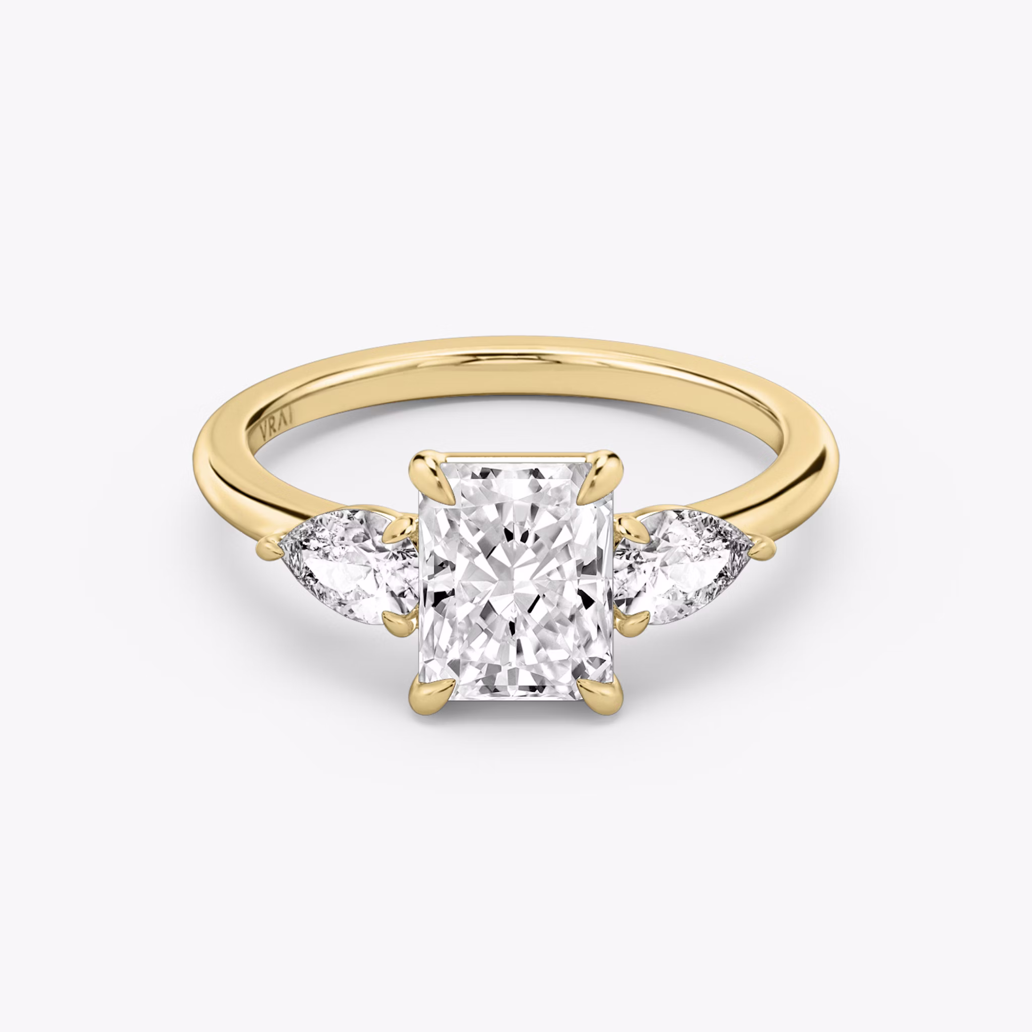 The Three Stone | Radiant | 18k | Yellow Gold | bandAccent: Plain | sideStoneCarat: 0.25ct | sideStoneShape: Pear | diamondOrientation: vertical | caratWeight: other