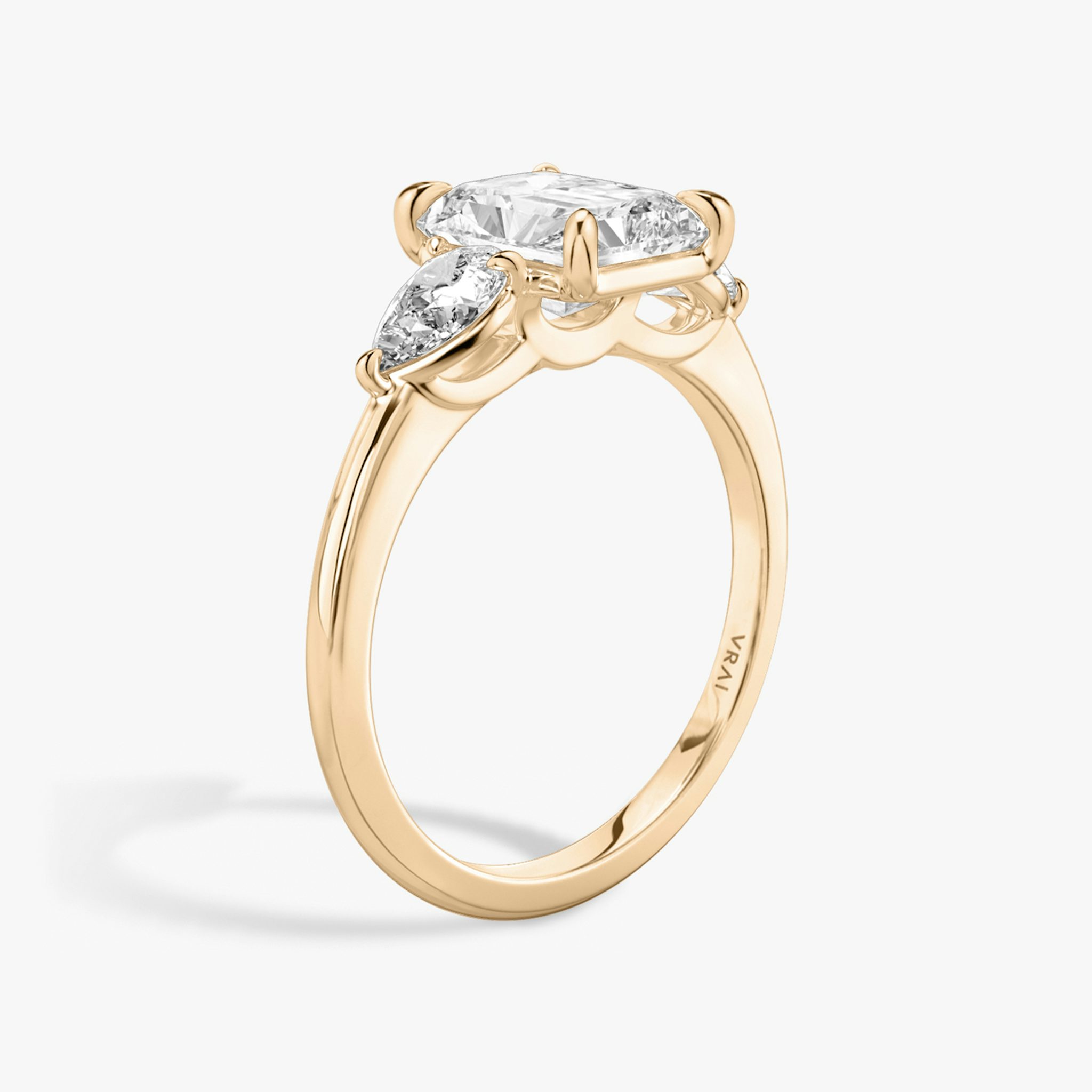 The Three Stone | Radiant | 14k | Rose Gold | bandAccent: Plain | sideStoneCarat: 0.25ct | sideStoneShape: Pear | diamondOrientation: vertical | caratWeight: other