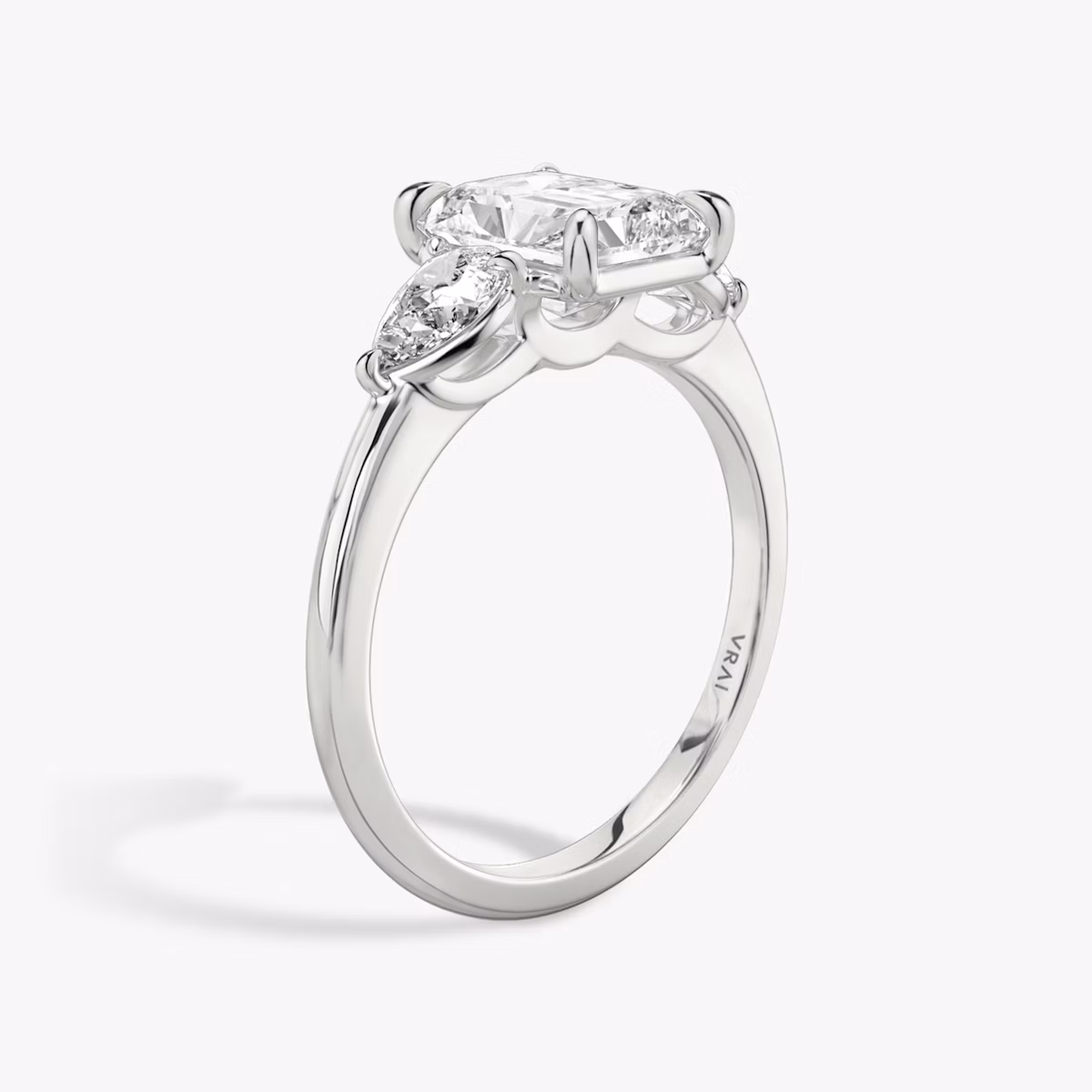 The Three Stone | Radiant | Platinum | bandAccent: Plain | sideStoneCarat: 0.25ct | sideStoneShape: Pear | diamondOrientation: vertical | caratWeight: other