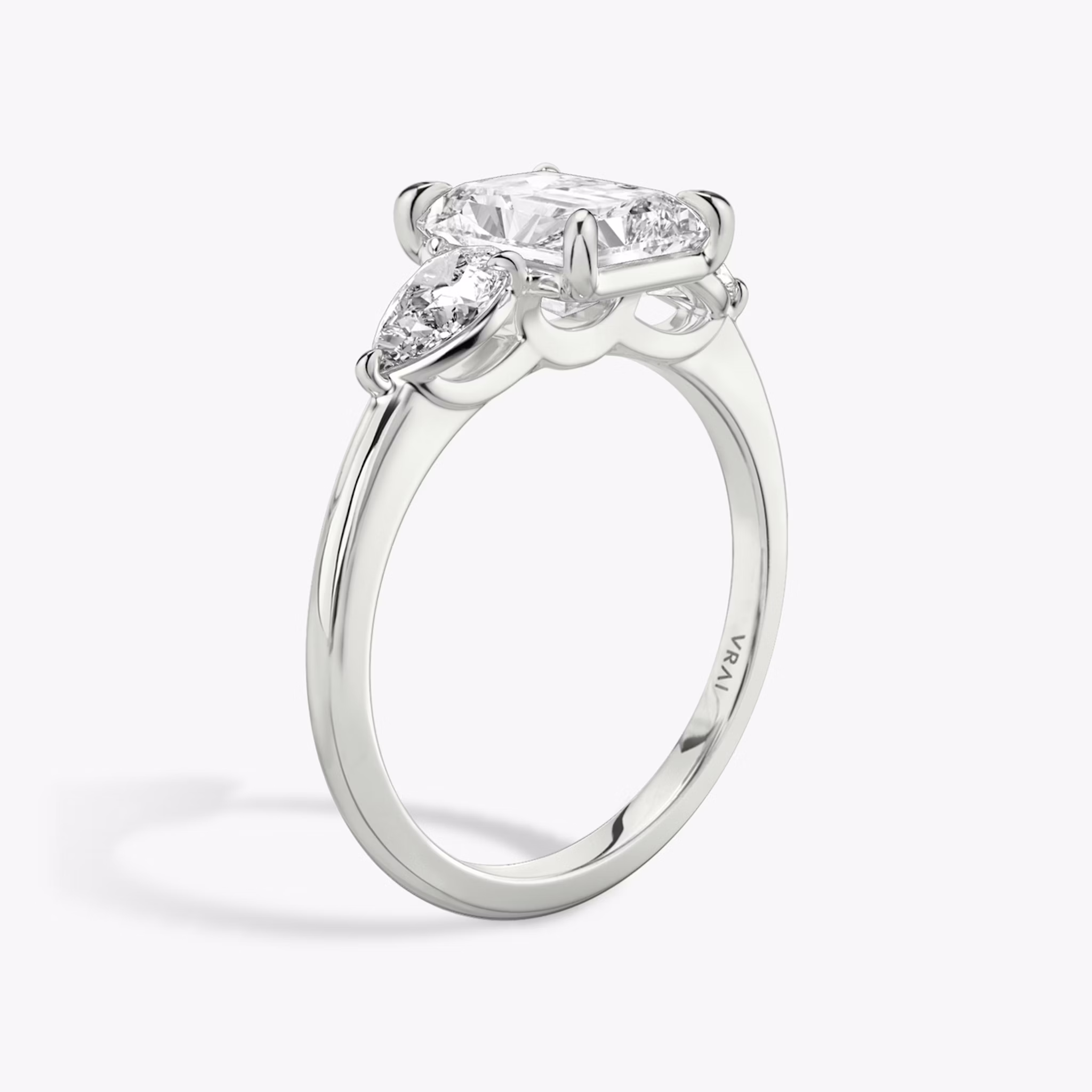 The Three Stone | Radiant | 18k | White Gold | bandAccent: Plain | sideStoneCarat: 0.25ct | sideStoneShape: Pear | diamondOrientation: vertical | caratWeight: other
