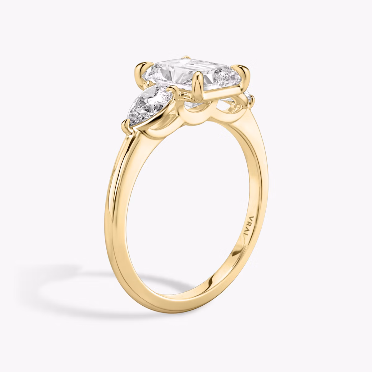 The Three Stone | Radiant | 18k | Yellow Gold | bandAccent: Plain | sideStoneCarat: 0.25ct | sideStoneShape: Pear | diamondOrientation: vertical | caratWeight: other