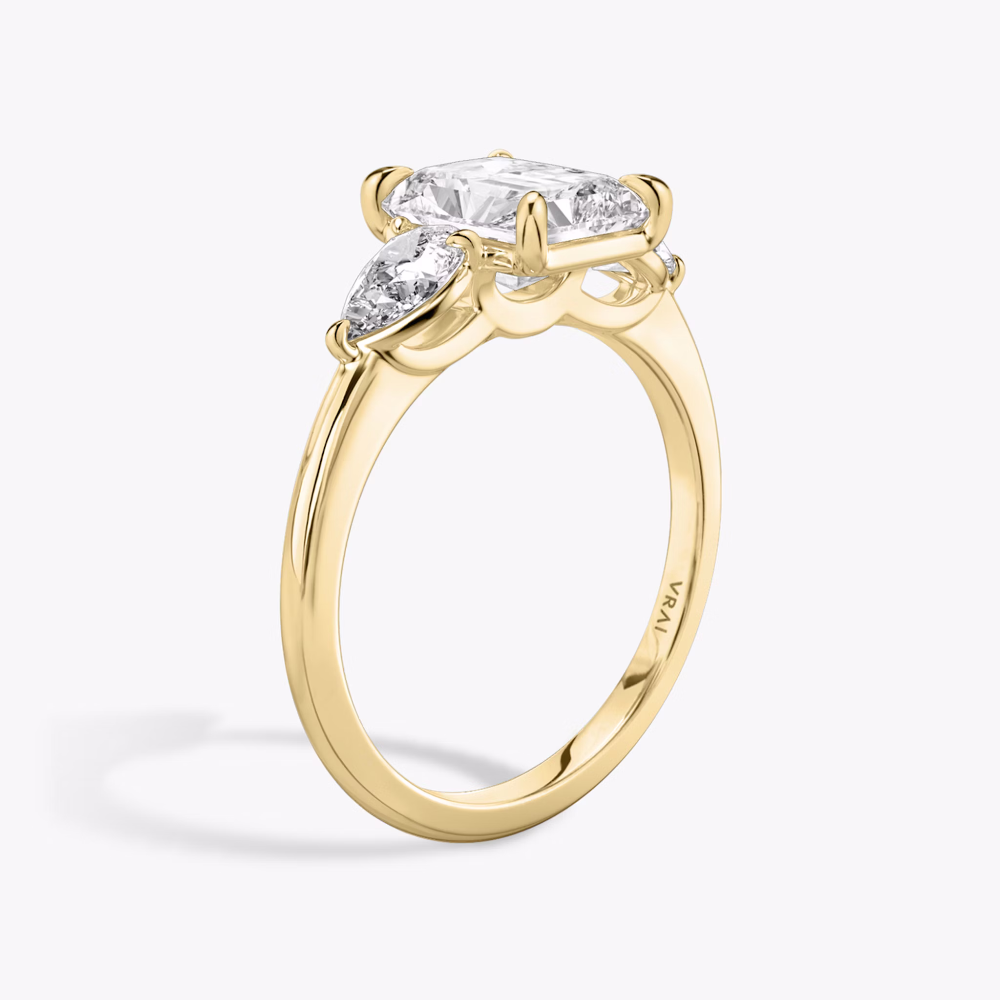 The Three Stone | Radiant | 18k | Yellow Gold | bandAccent: Plain | sideStoneCarat: 0.25ct | sideStoneShape: Pear | diamondOrientation: vertical | caratWeight: other