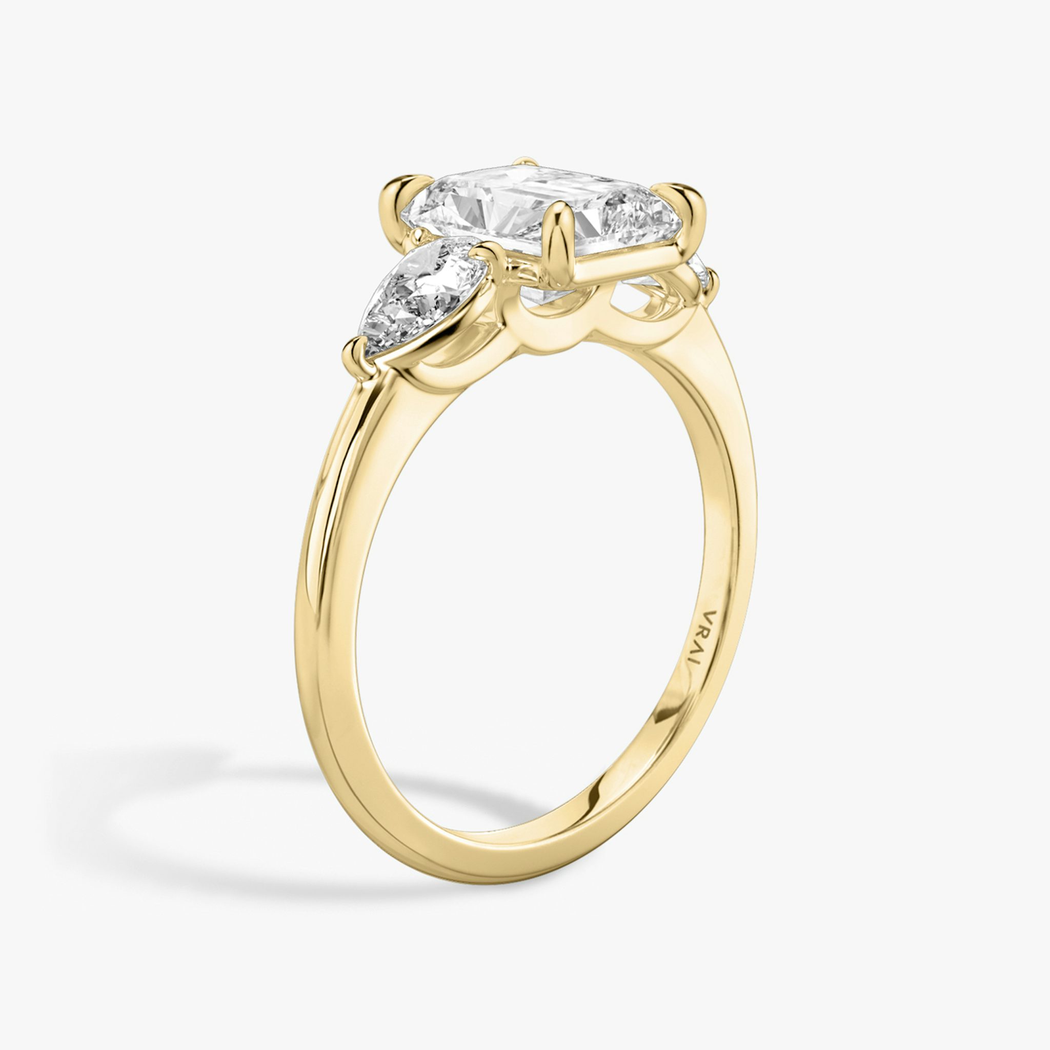 The Three Stone | Radiant | 18k | Yellow Gold | bandAccent: Plain | sideStoneCarat: 0.25ct | sideStoneShape: Pear | diamondOrientation: vertical | caratWeight: other