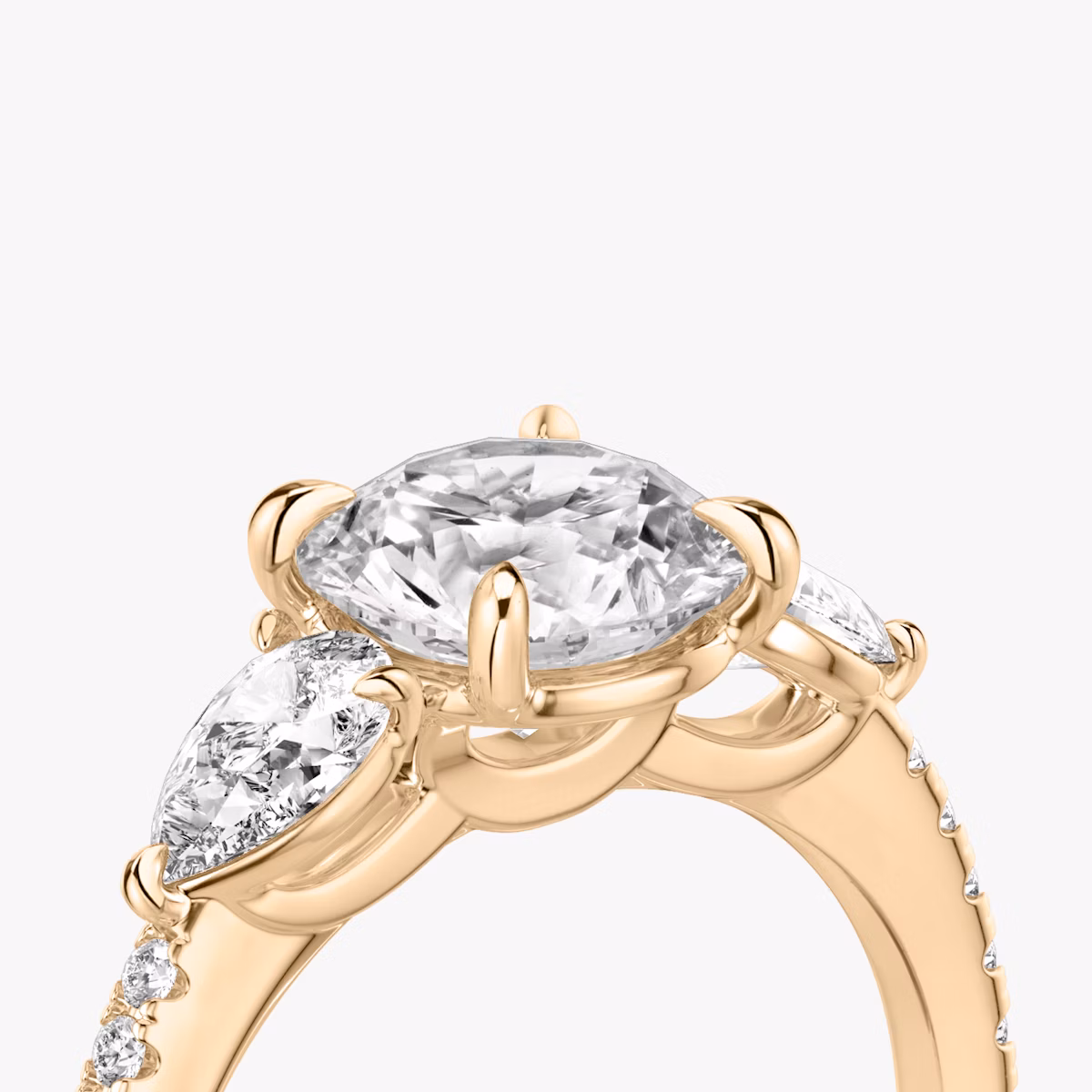 The Three Stone | Round Brilliant | 14k | Rose Gold | bandAccent: Pavé | caratWeight: other | sideStoneCarat: 0.25ct | sideStoneShape: Pear | diamondOrientation: vertical