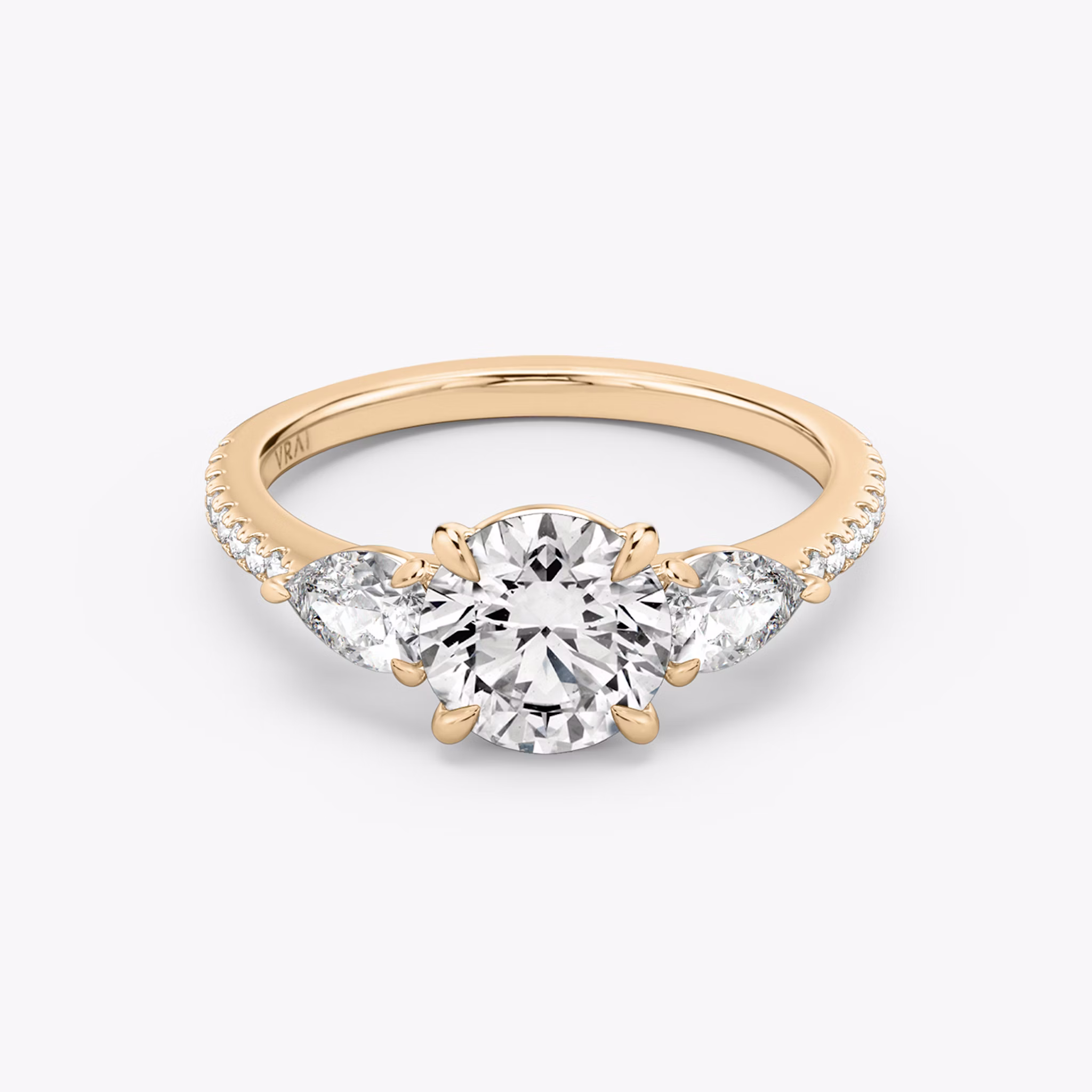 The Three Stone | Round Brilliant | 14k | Rose Gold | bandAccent: Pavé | caratWeight: other | sideStoneCarat: 0.25ct | sideStoneShape: Pear | diamondOrientation: vertical