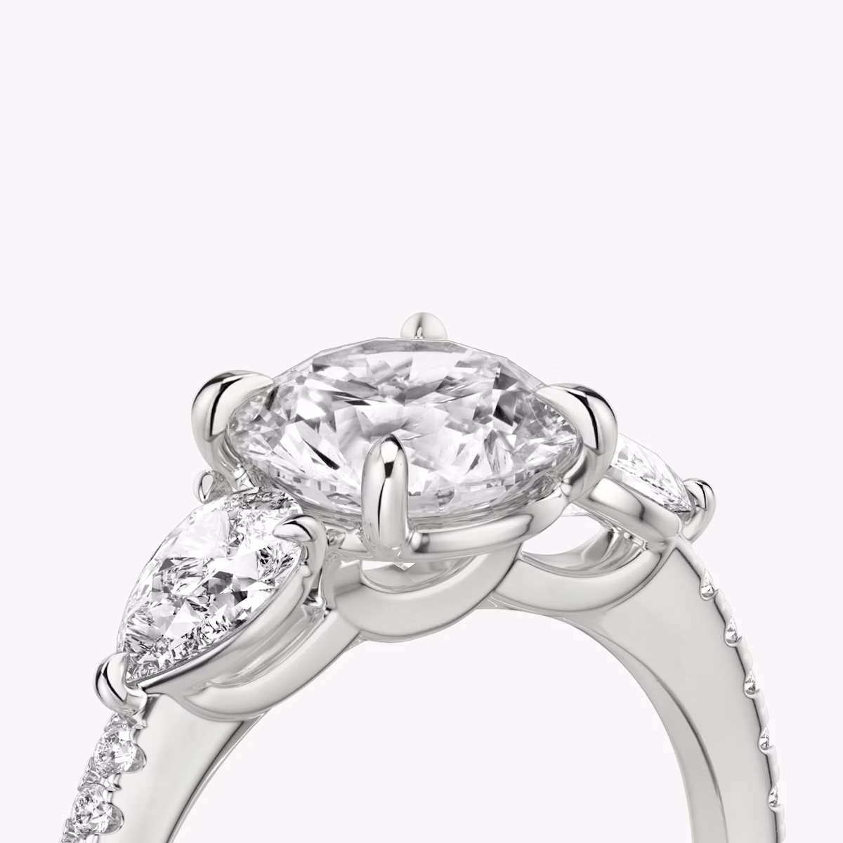 The Three Stone | Round Brilliant | 18k | White Gold | bandAccent: Pavé | caratWeight: other | sideStoneCarat: 0.25ct | sideStoneShape: Pear | diamondOrientation: vertical