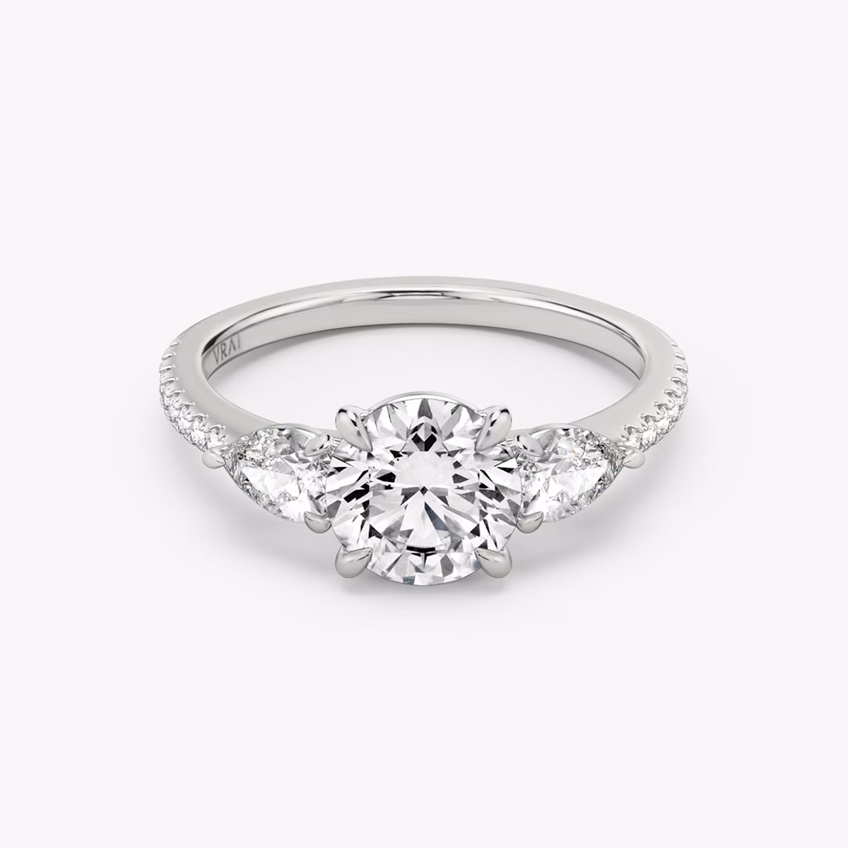The Three Stone | Round Brilliant | 18k | White Gold | bandAccent: Pavé | caratWeight: other | sideStoneCarat: 0.25ct | sideStoneShape: Pear | diamondOrientation: vertical