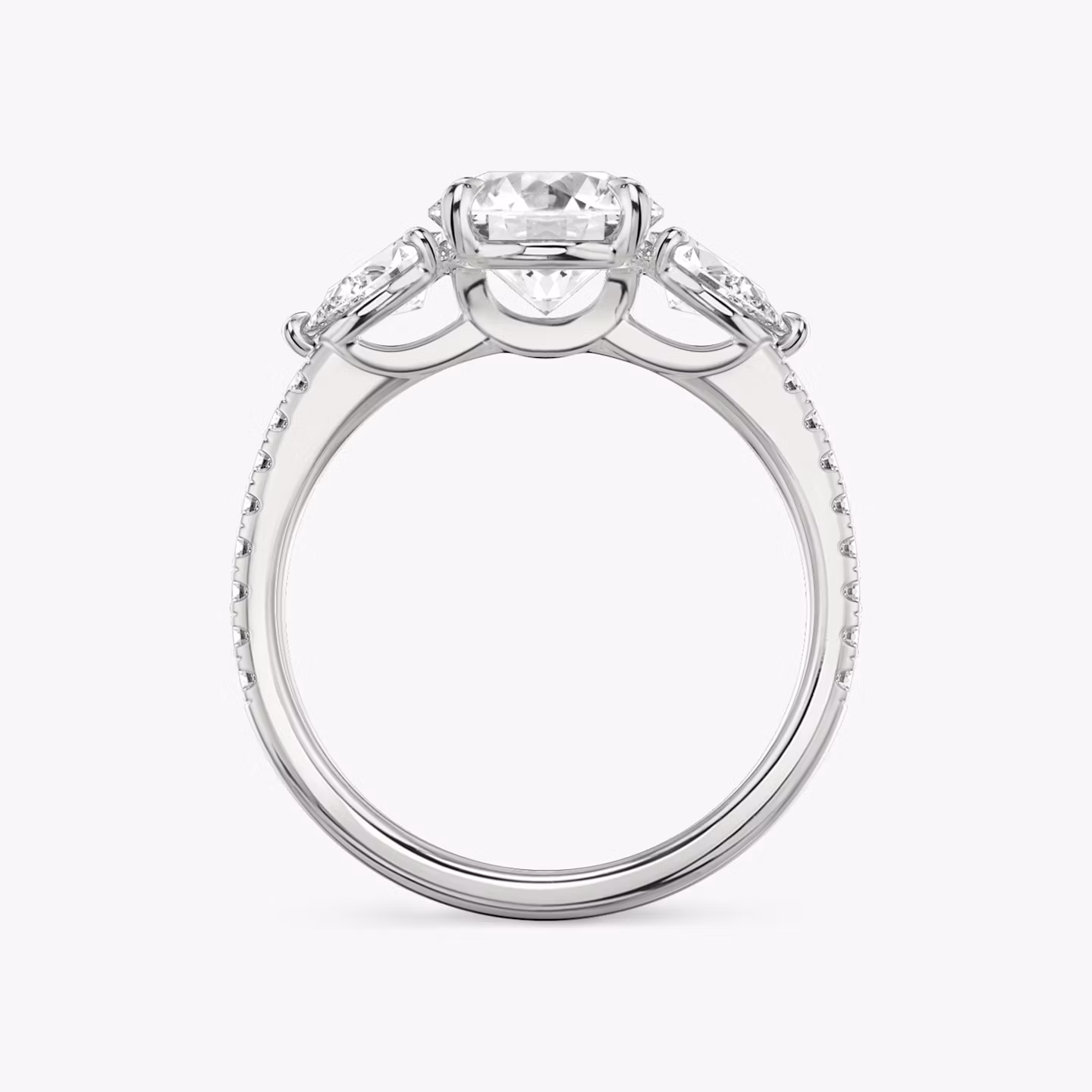 The Three Stone | Round Brilliant | Platinum | bandAccent: Pavé | caratWeight: other | sideStoneCarat: 0.25ct | sideStoneShape: Pear | diamondOrientation: vertical