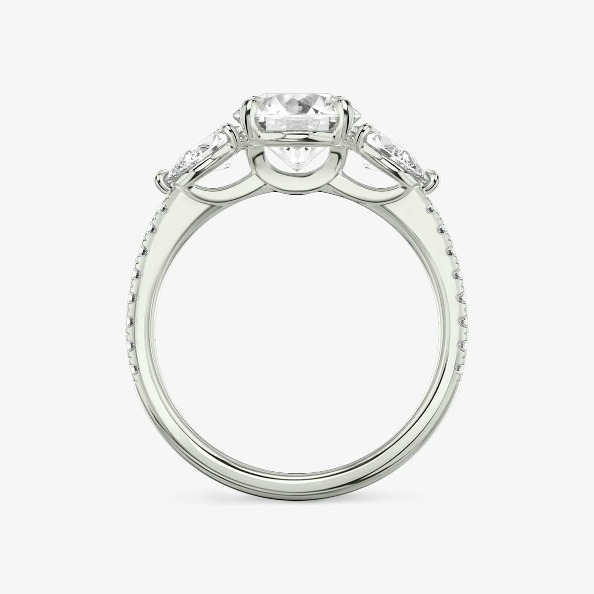 The Three Stone | Round Brilliant | Platinum | bandAccent: Pavé | caratWeight: other | sideStoneCarat: 0.25ct | sideStoneShape: Pear | diamondOrientation: vertical