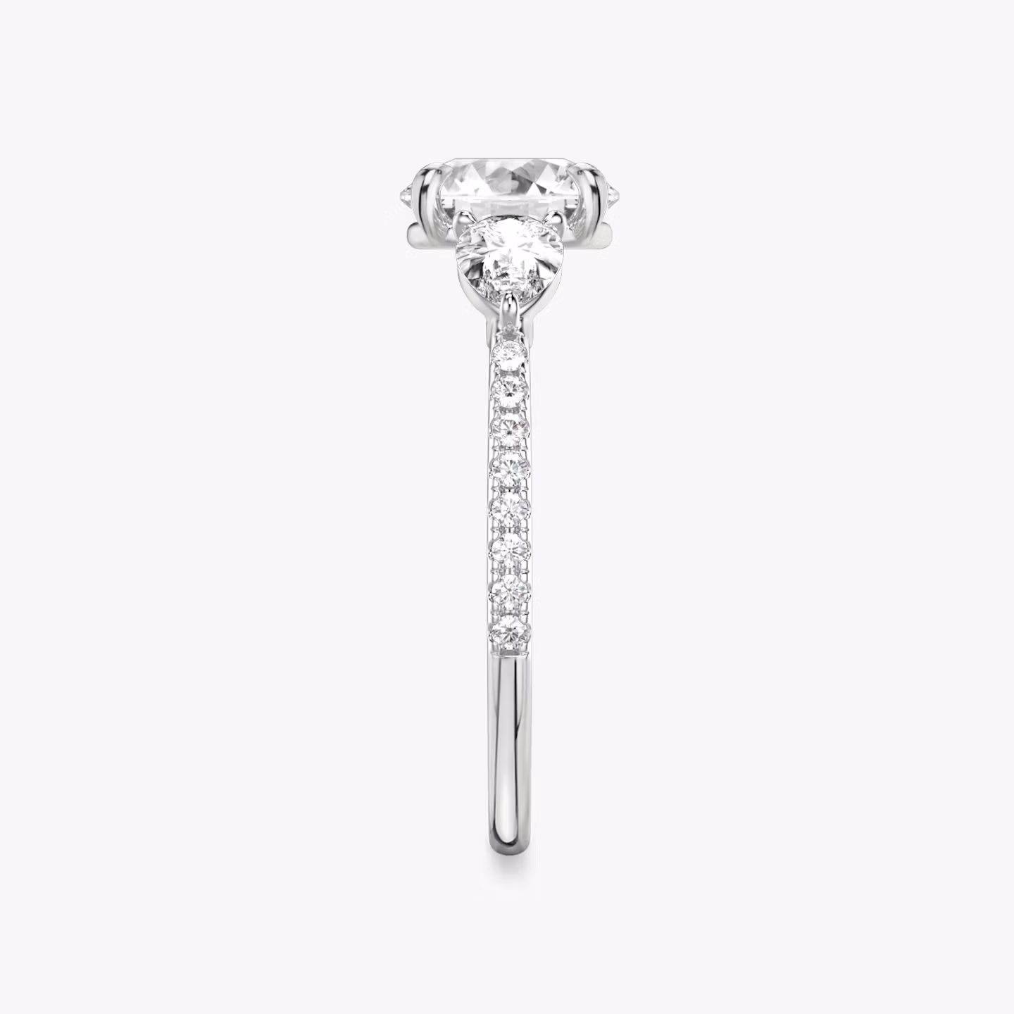 The Three Stone | Round Brilliant | Platinum | bandAccent: Pavé | caratWeight: other | sideStoneCarat: 0.25ct | sideStoneShape: Pear | diamondOrientation: vertical