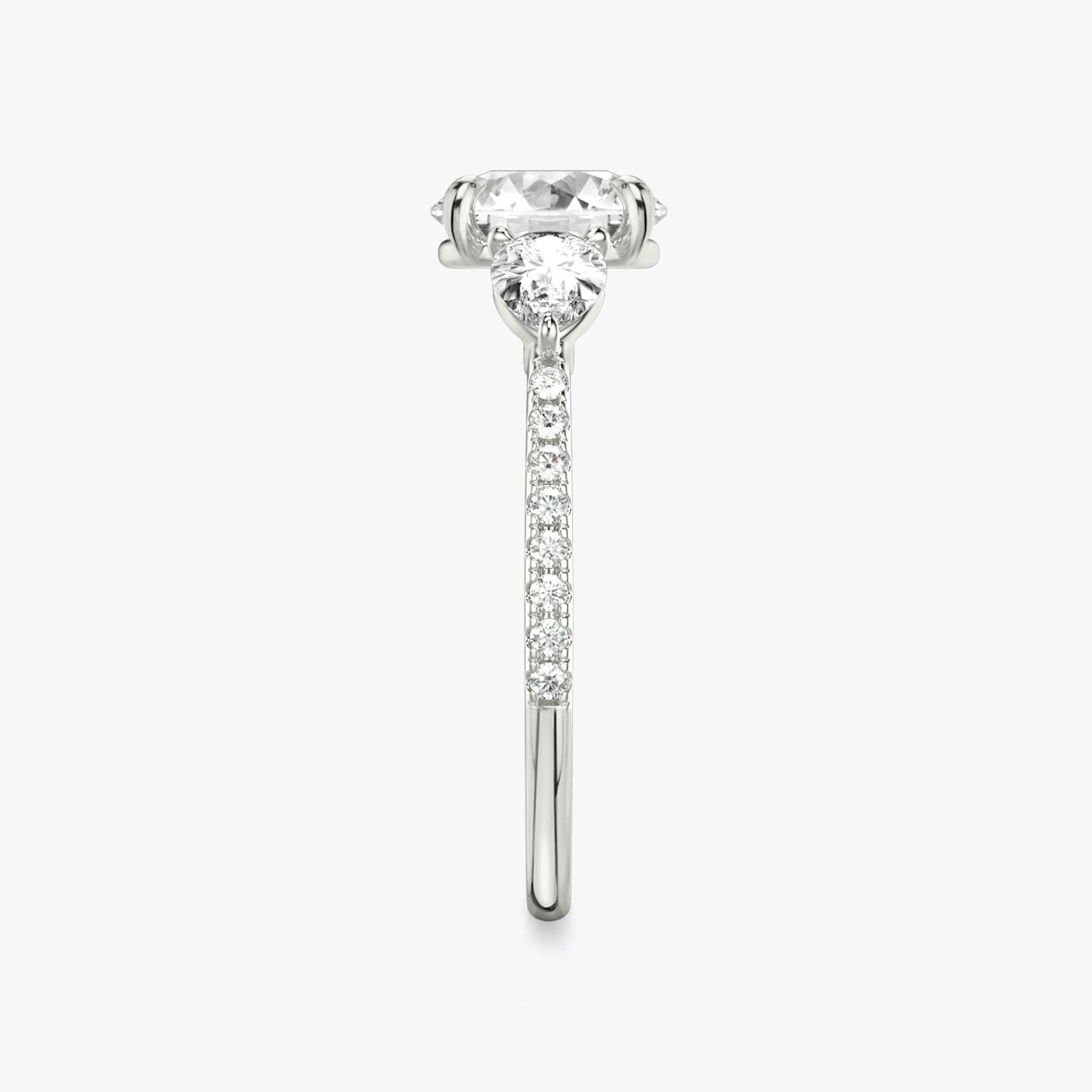The Three Stone | Round Brilliant | Platinum | bandAccent: Pavé | caratWeight: other | sideStoneCarat: 0.25ct | sideStoneShape: Pear | diamondOrientation: vertical