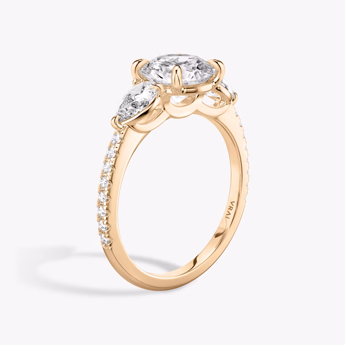 The Three Stone | Round Brilliant | 14k | Rose Gold | bandAccent: Pavé | caratWeight: other | sideStoneCarat: 0.25ct | sideStoneShape: Pear | diamondOrientation: vertical