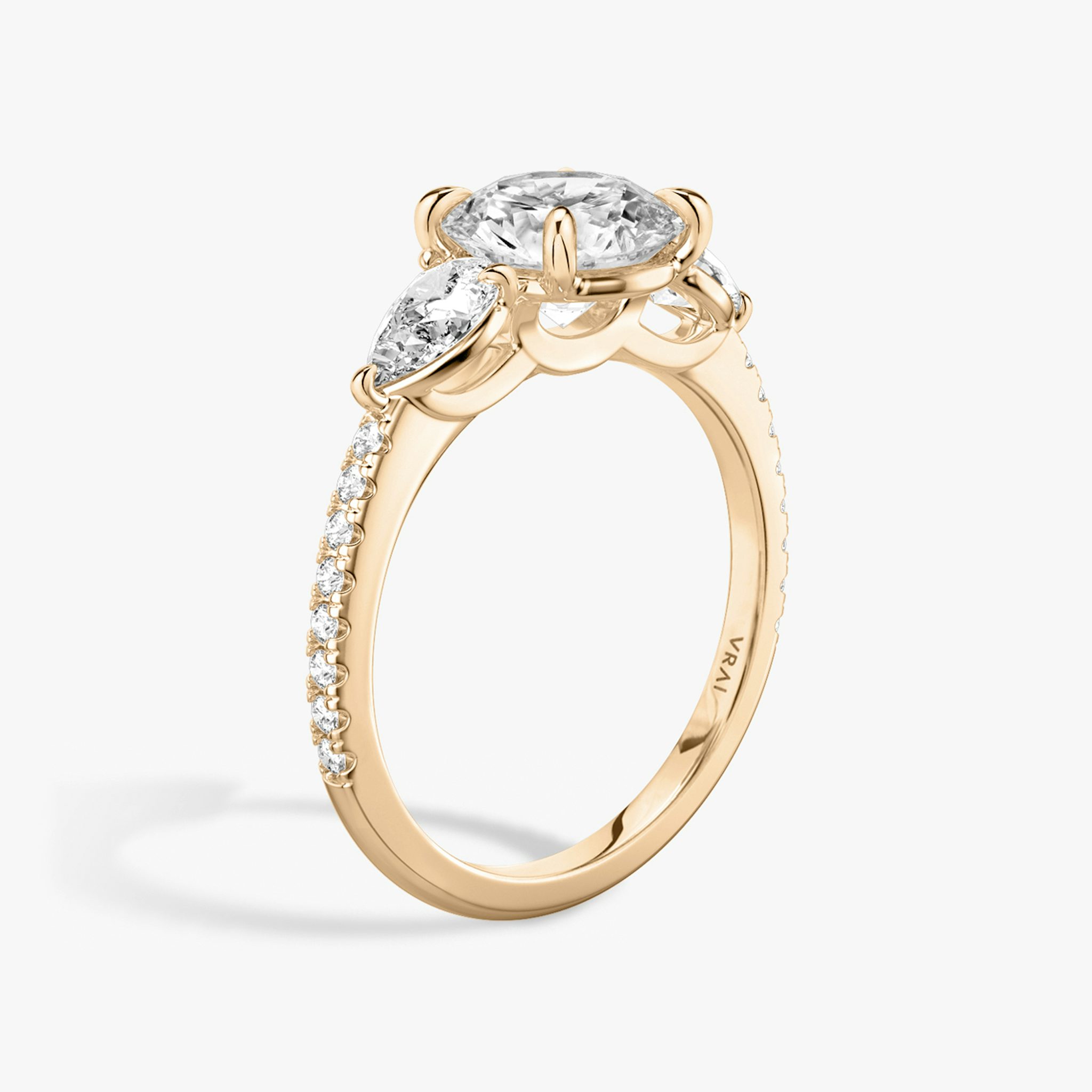 The Three Stone | Round Brilliant | 14k | Rose Gold | bandAccent: Pavé | caratWeight: other | sideStoneCarat: 0.25ct | sideStoneShape: Pear | diamondOrientation: vertical