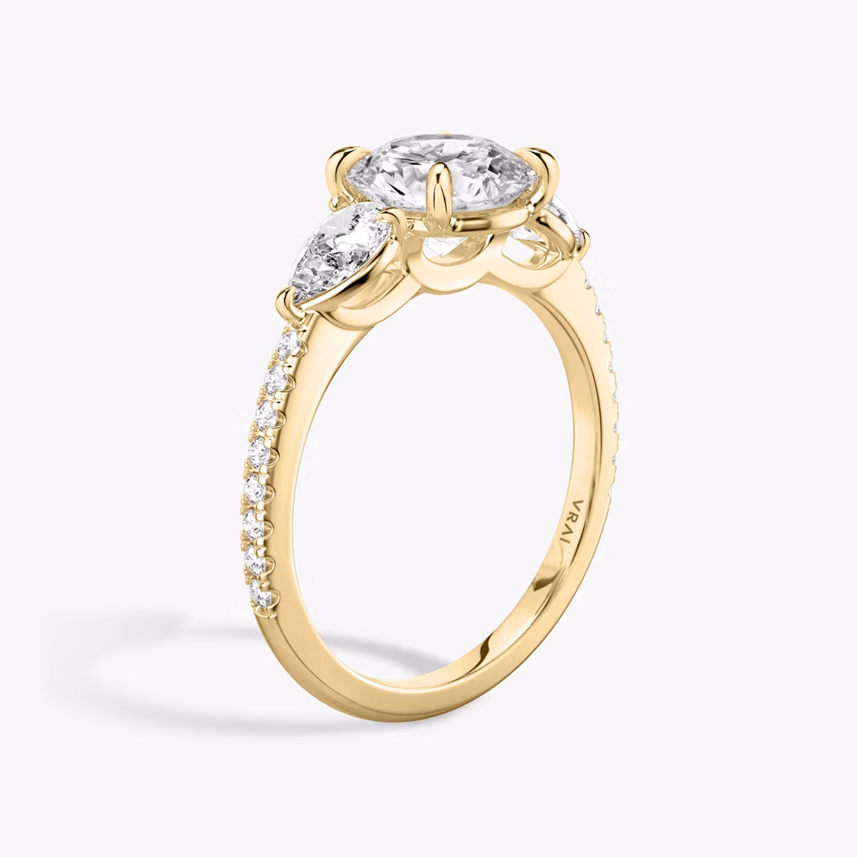 The Three Stone | Round Brilliant | 18k | Yellow Gold | bandAccent: Pavé | caratWeight: other | sideStoneCarat: 0.25ct | sideStoneShape: Pear | diamondOrientation: vertical