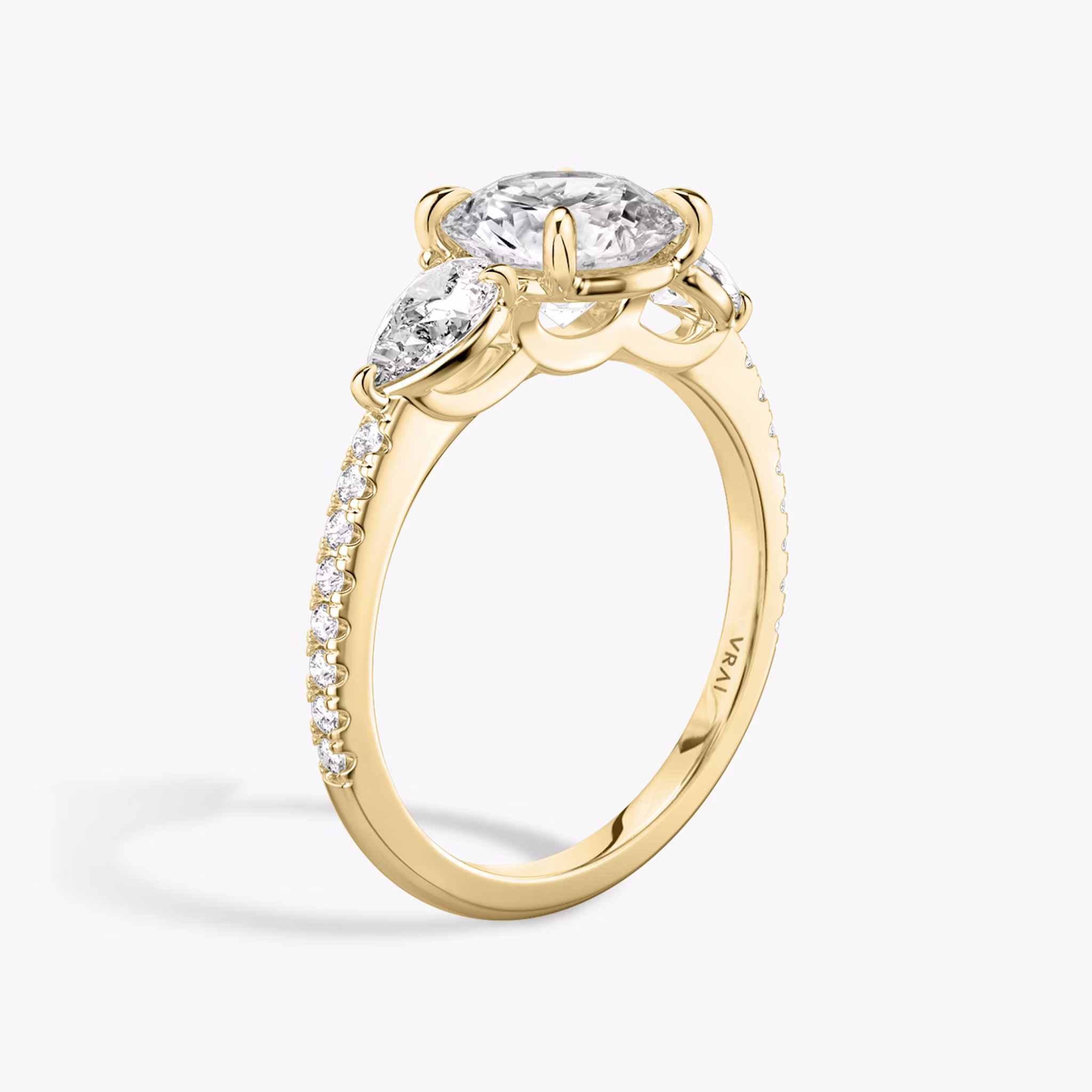 The Three Stone | Round Brilliant | 18k | Yellow Gold | bandAccent: Pavé | caratWeight: other | sideStoneCarat: 0.25ct | sideStoneShape: Pear | diamondOrientation: vertical