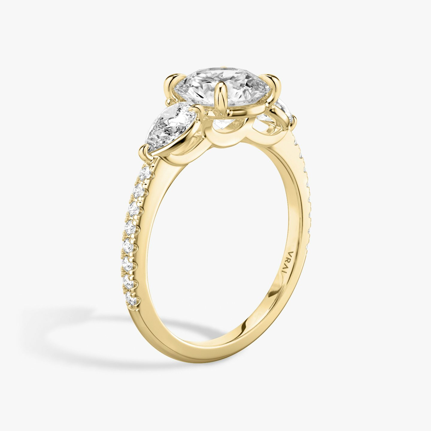 The Three Stone | Round Brilliant | 18k | Yellow Gold | bandAccent: Pavé | caratWeight: other | sideStoneCarat: 0.25ct | sideStoneShape: Pear | diamondOrientation: vertical