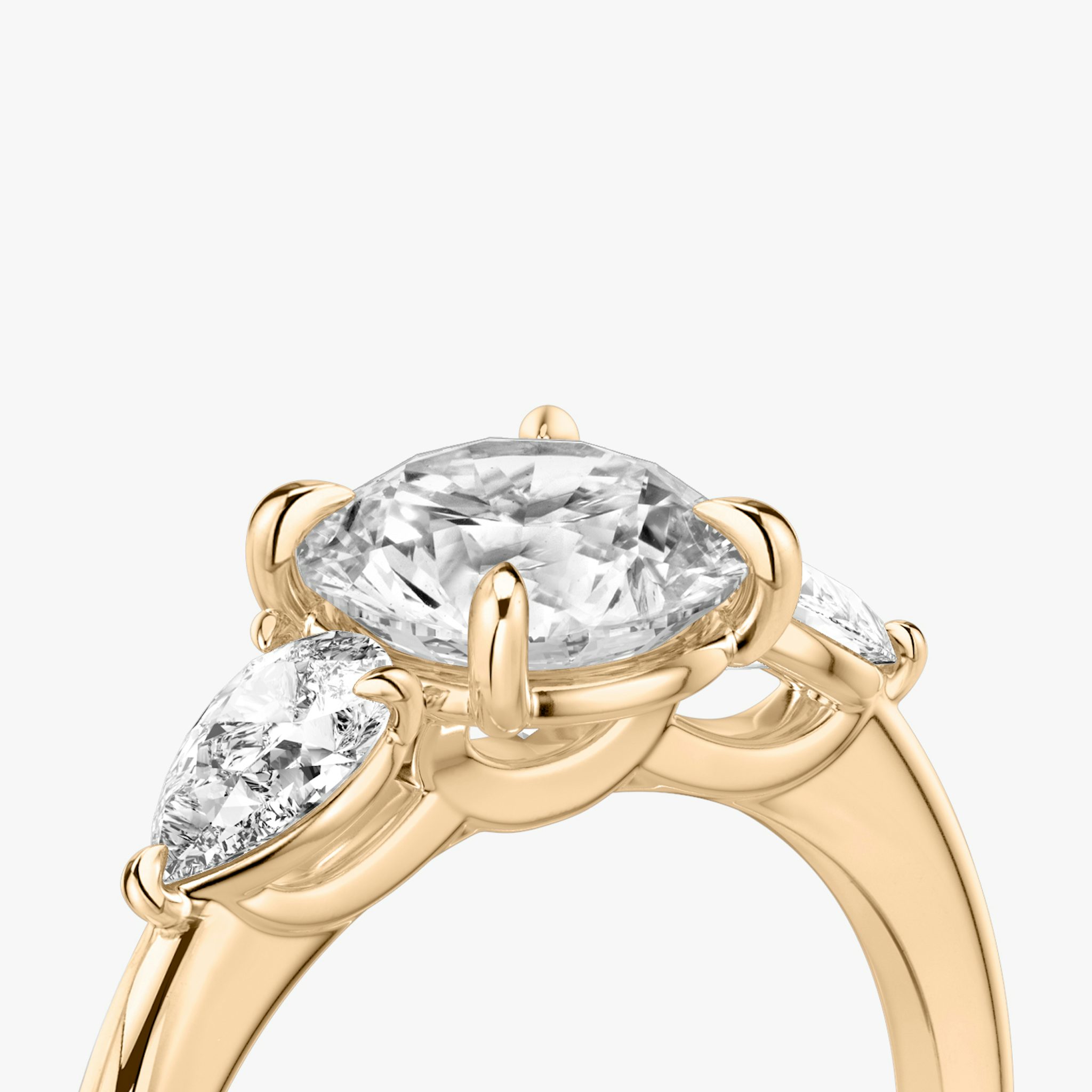 The Three Stone | Round Brilliant | 14k | Rose Gold | bandAccent: Plain | caratWeight: other | sideStoneCarat: 0.25ct | sideStoneShape: Pear | diamondOrientation: vertical
