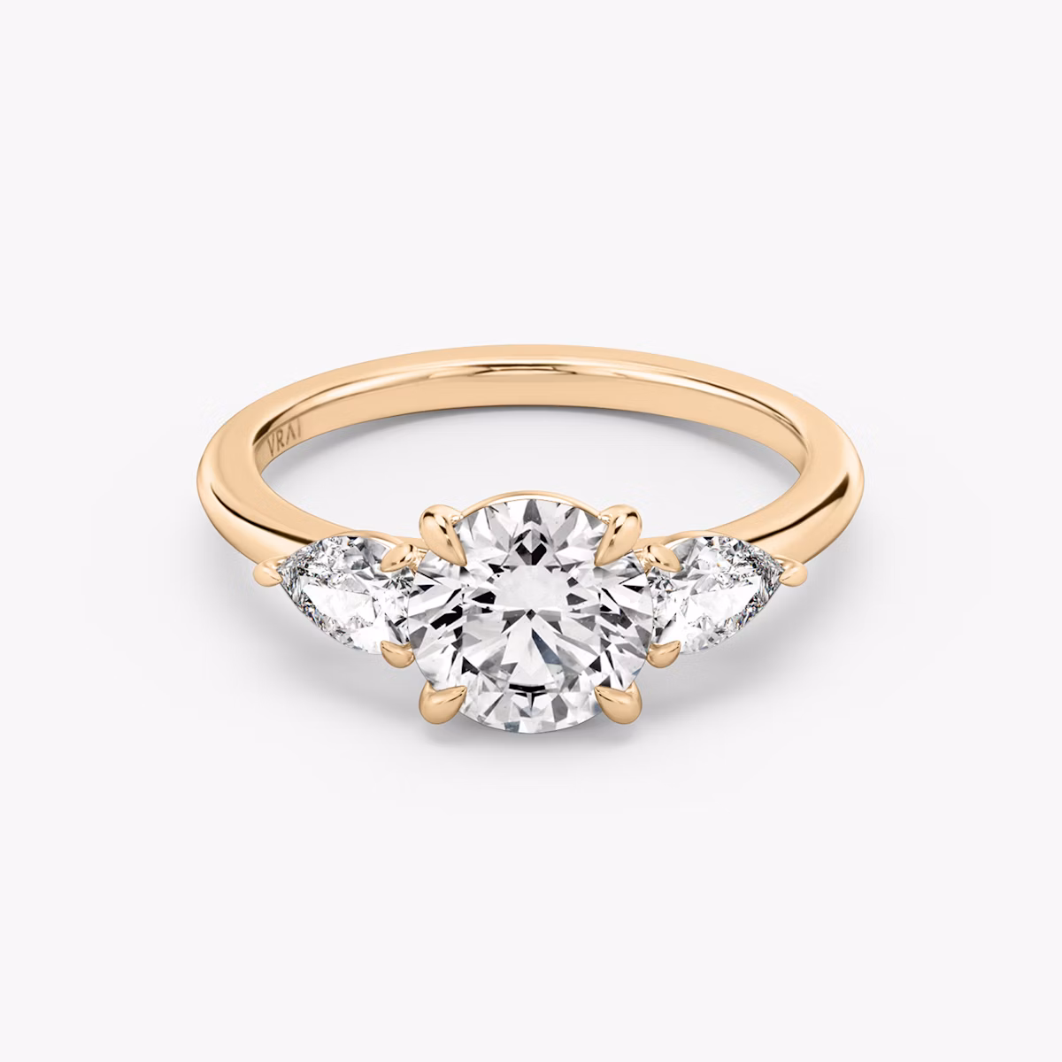 The Three Stone | Round Brilliant | 14k | Rose Gold | bandAccent: Plain | caratWeight: other | sideStoneCarat: 0.25ct | sideStoneShape: Pear | diamondOrientation: vertical