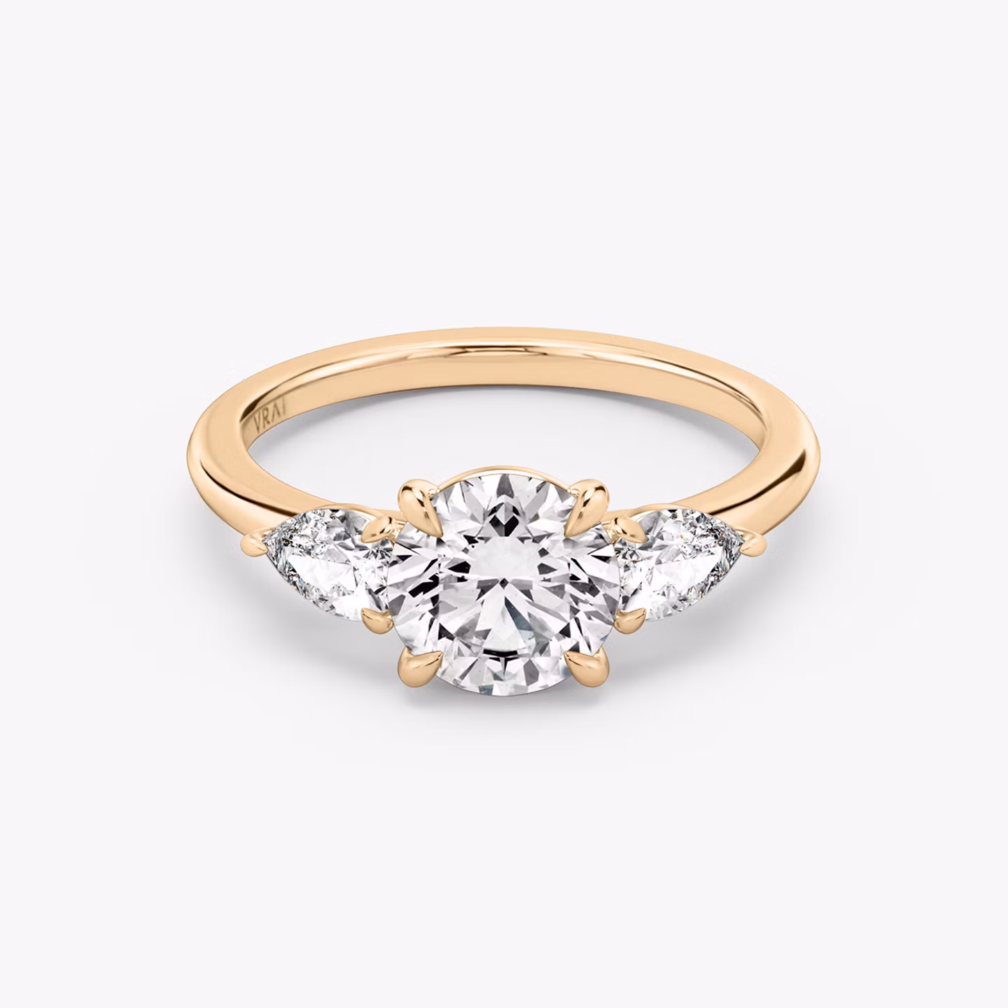 The Three Stone | Round Brilliant | 14k | Rose Gold | bandAccent: Plain | caratWeight: other | sideStoneCarat: 0.25ct | sideStoneShape: Pear | diamondOrientation: vertical