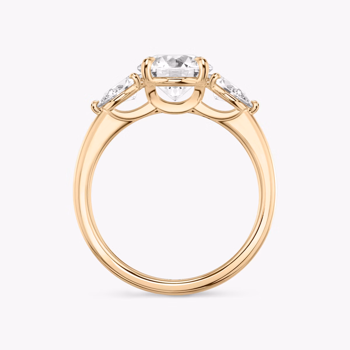 The Three Stone | Round Brilliant | 14k | Rose Gold | bandAccent: Plain | caratWeight: other | sideStoneCarat: 0.25ct | sideStoneShape: Pear | diamondOrientation: vertical