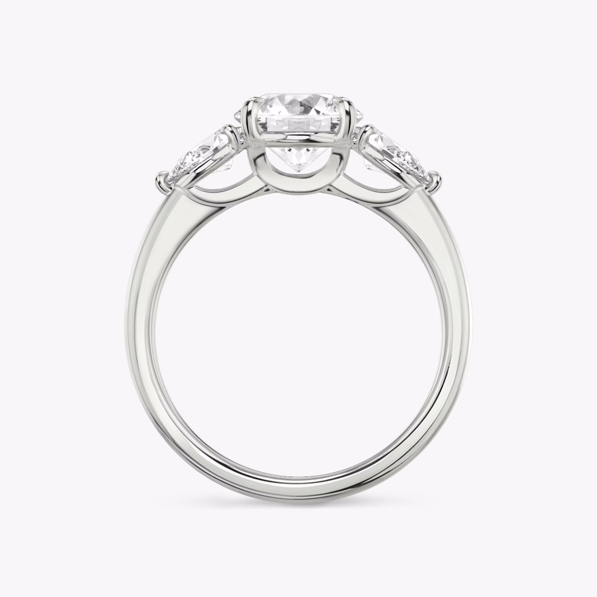 The Three Stone | Round Brilliant | Platinum | bandAccent: Plain | caratWeight: other | sideStoneCarat: 0.25ct | sideStoneShape: Pear | diamondOrientation: vertical