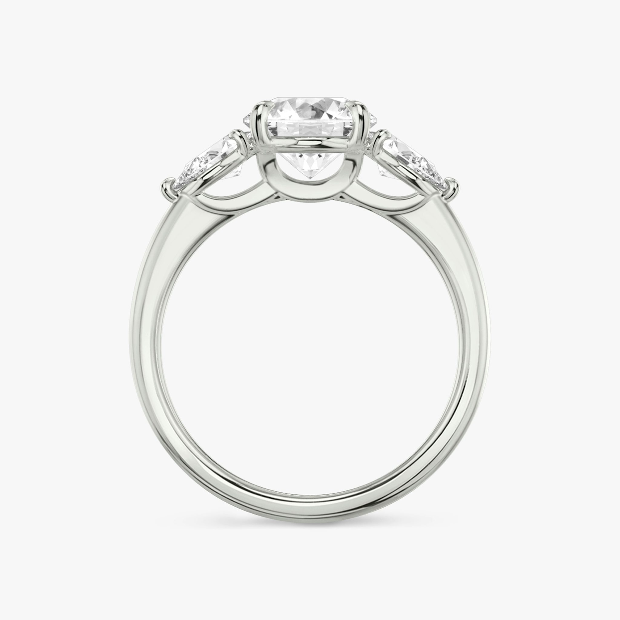 The Three Stone | Round Brilliant | Platinum | bandAccent: Plain | caratWeight: other | sideStoneCarat: 0.25ct | sideStoneShape: Pear | diamondOrientation: vertical