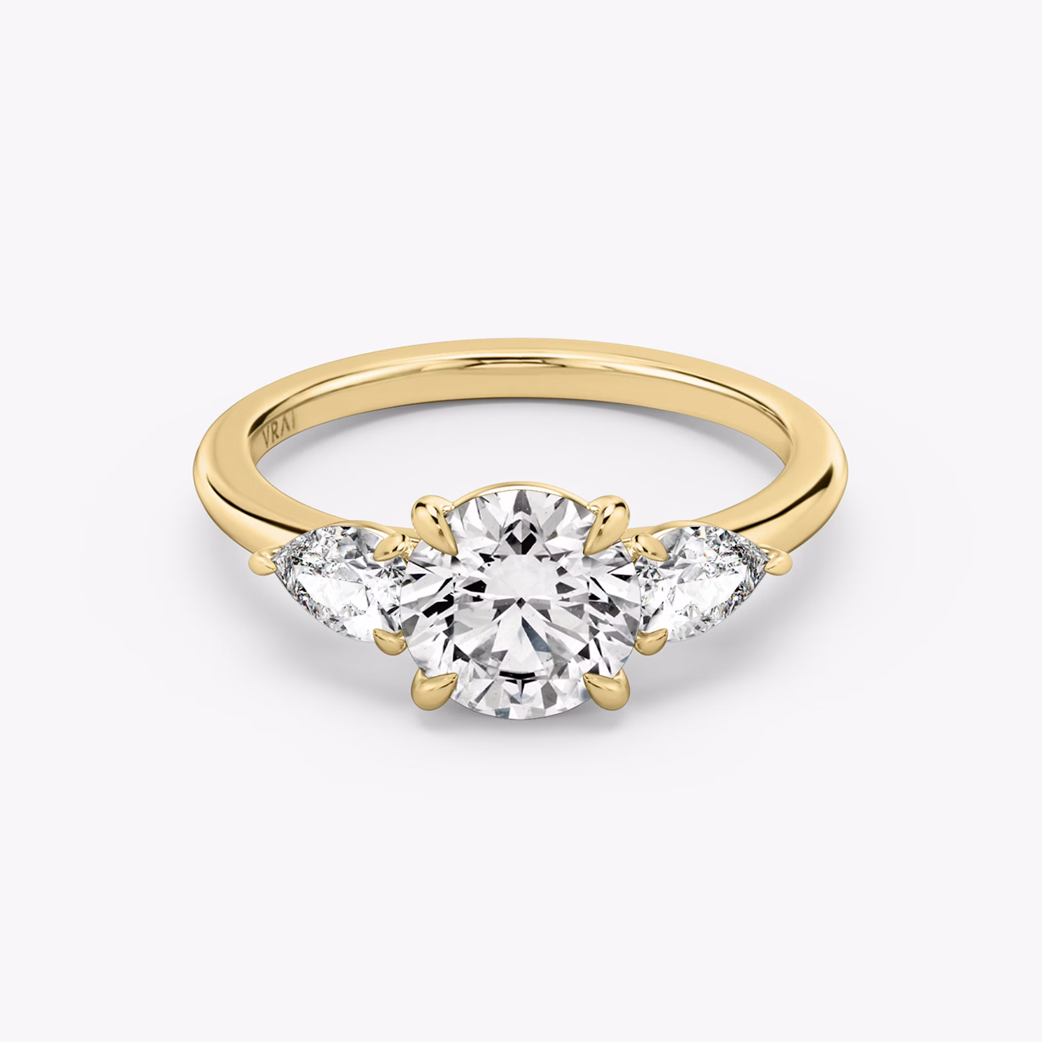 The Three Stone | Round Brilliant | 18k | Yellow Gold | bandAccent: Plain | caratWeight: other | sideStoneCarat: 0.25ct | sideStoneShape: Pear | diamondOrientation: vertical