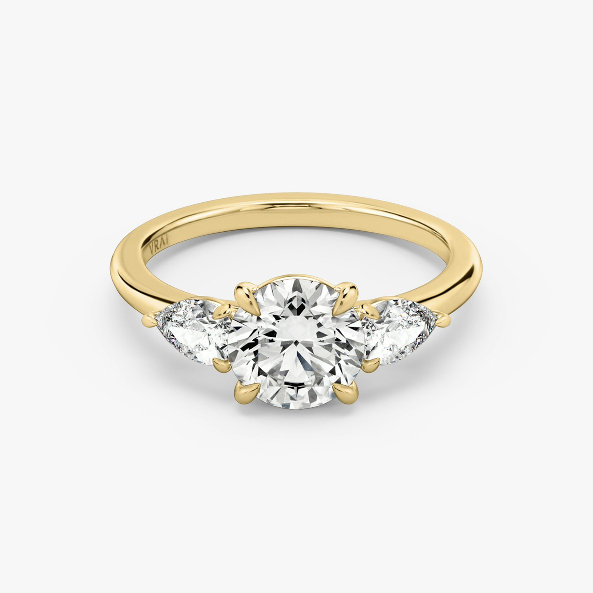 The Three Stone | Round Brilliant | 18k | Yellow Gold | bandAccent: Plain | caratWeight: other | sideStoneCarat: 0.25ct | sideStoneShape: Pear | diamondOrientation: vertical