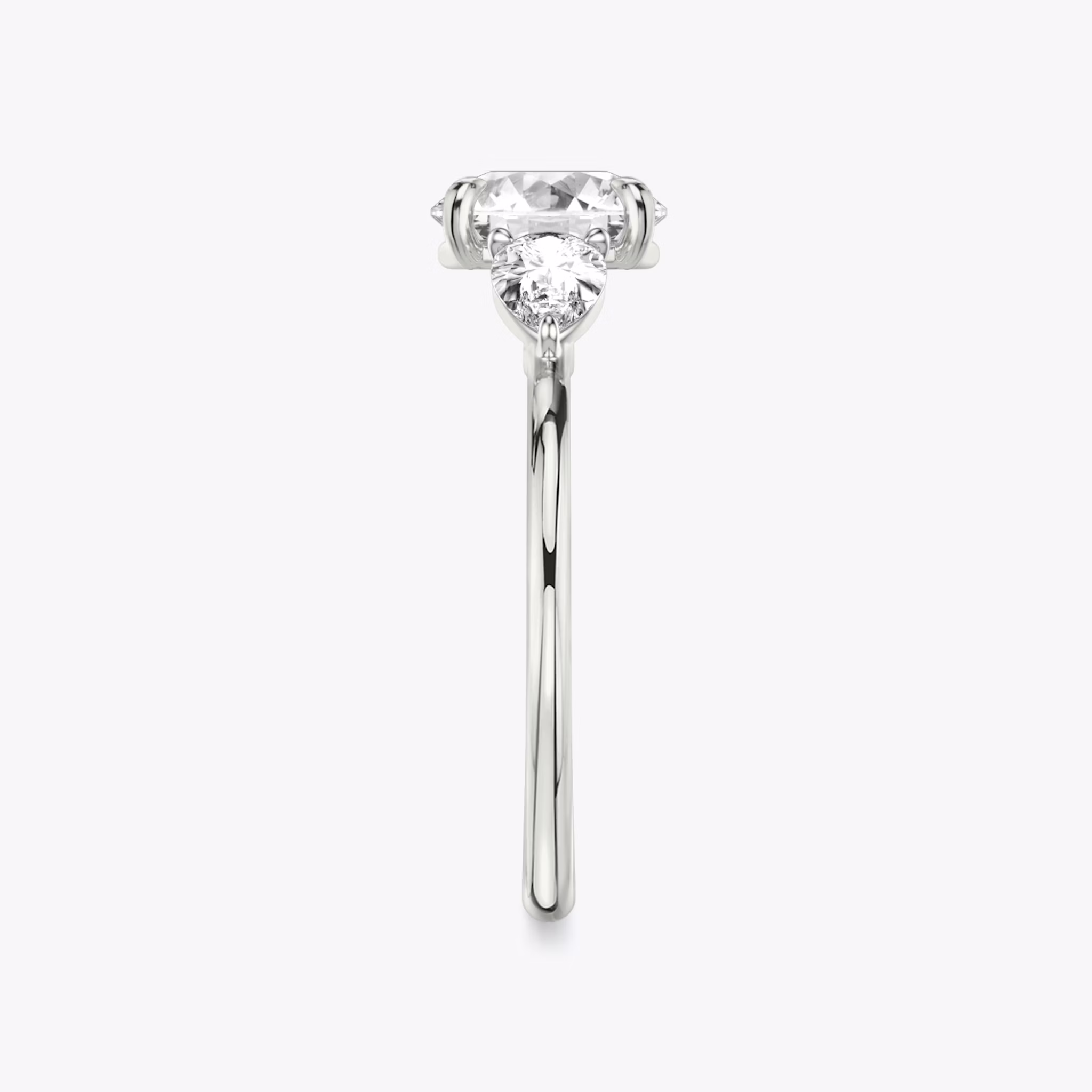 The Three Stone | Round Brilliant | Platinum | bandAccent: Plain | caratWeight: other | sideStoneCarat: 0.25ct | sideStoneShape: Pear | diamondOrientation: vertical