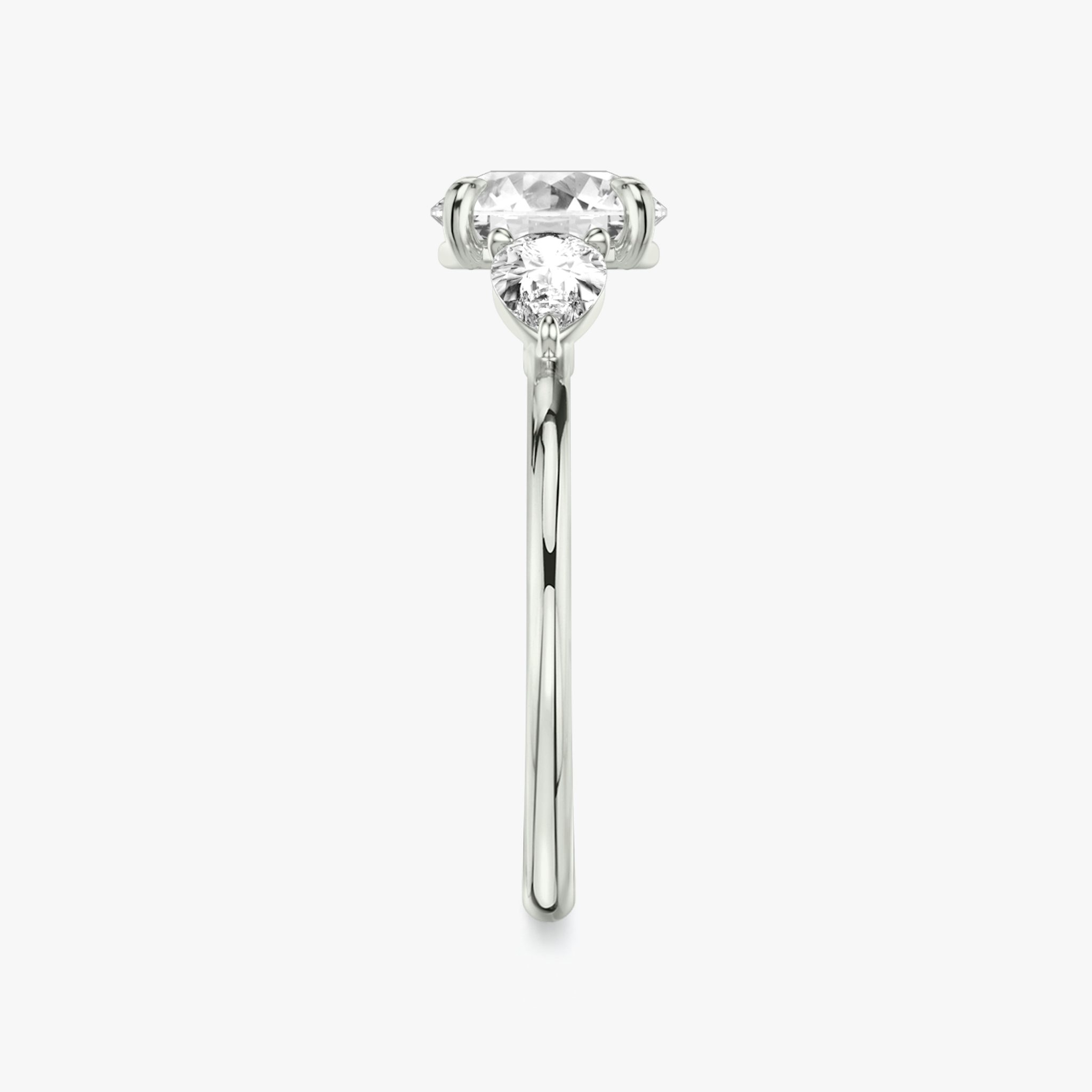 The Three Stone | Round Brilliant | Platinum | bandAccent: Plain | caratWeight: other | sideStoneCarat: 0.25ct | sideStoneShape: Pear | diamondOrientation: vertical