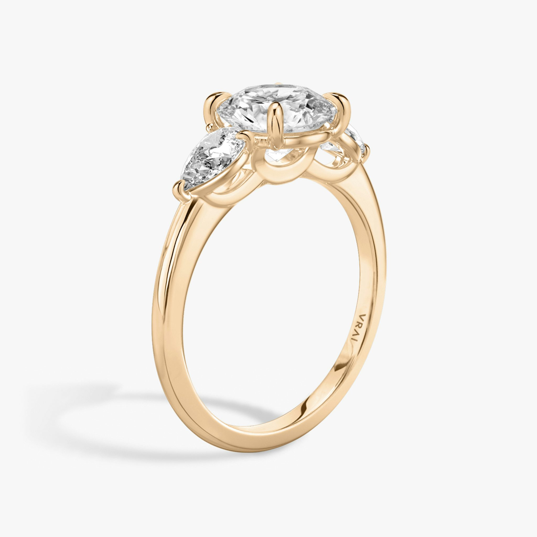 The Three Stone | Round Brilliant | 14k | Rose Gold | bandAccent: Plain | caratWeight: other | sideStoneCarat: 0.25ct | sideStoneShape: Pear | diamondOrientation: vertical
