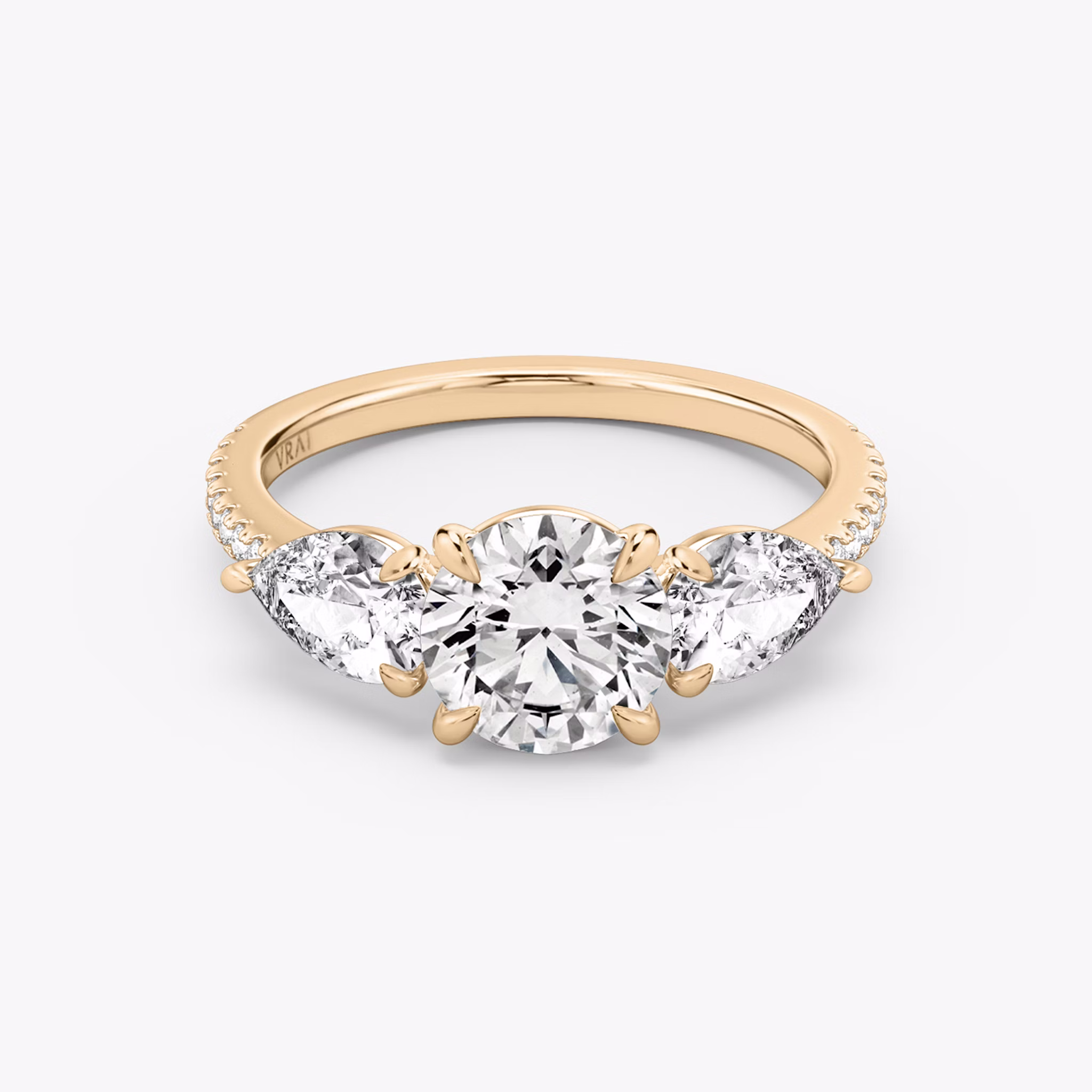 The Three Stone | Round Brilliant | 14k | Rose Gold | bandAccent: Pavé | caratWeight: other | sideStoneCarat: 0.50ct | sideStoneShape: Pear | diamondOrientation: vertical
