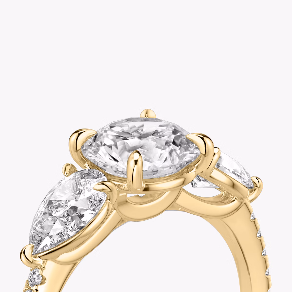 The Three Stone | Round Brilliant | 18k | Yellow Gold | bandAccent: Pavé | caratWeight: other | sideStoneCarat: 0.50ct | sideStoneShape: Pear | diamondOrientation: vertical