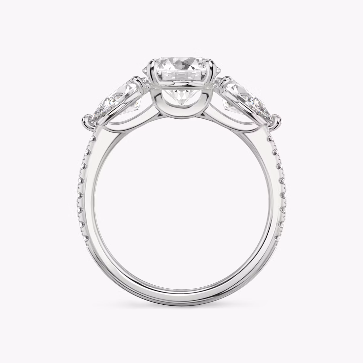The Three Stone | Round Brilliant | Platinum | bandAccent: Pavé | caratWeight: other | sideStoneCarat: 0.50ct | sideStoneShape: Pear | diamondOrientation: vertical