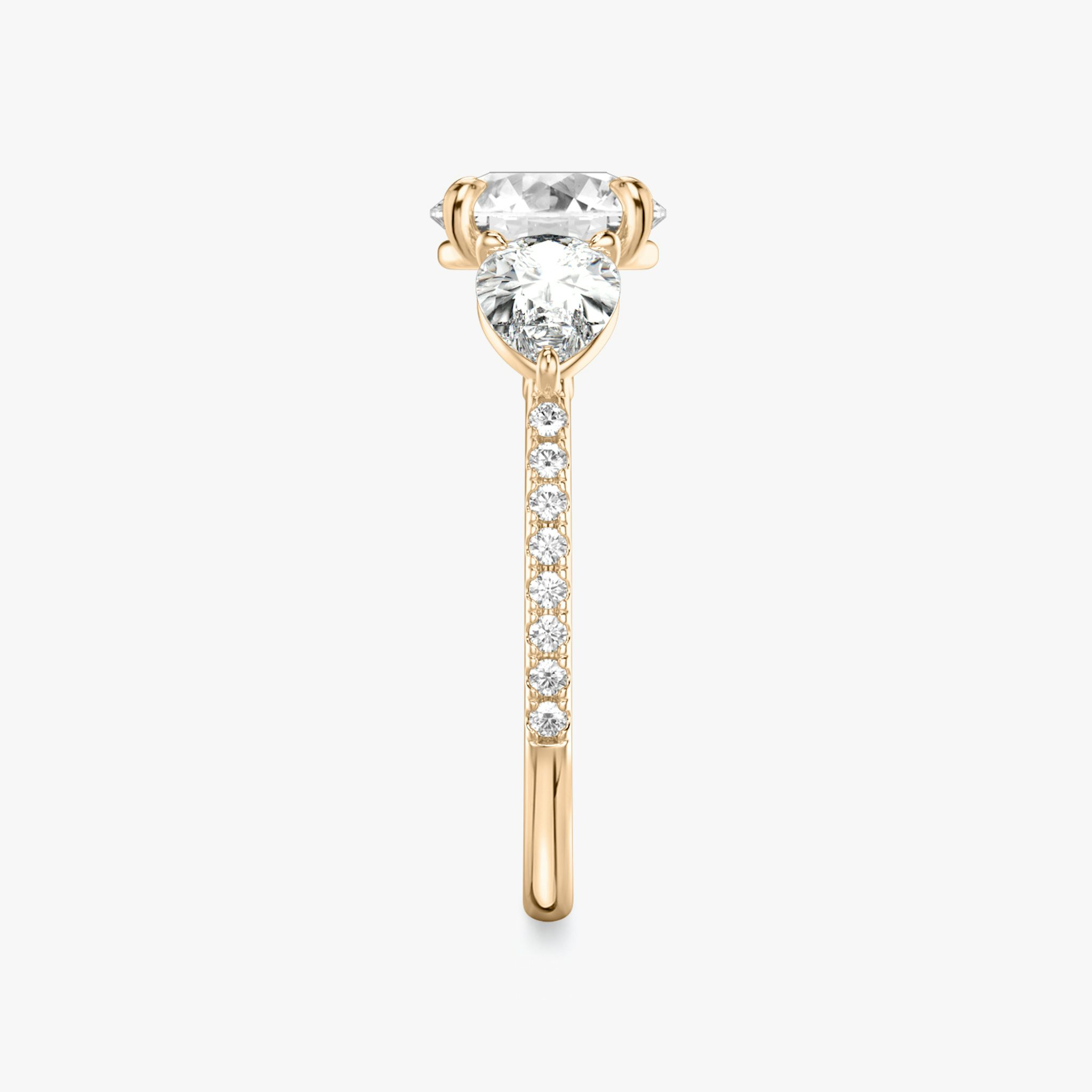 The Three Stone | Round Brilliant | 14k | Rose Gold | bandAccent: Pavé | caratWeight: other | sideStoneCarat: 0.50ct | sideStoneShape: Pear | diamondOrientation: vertical