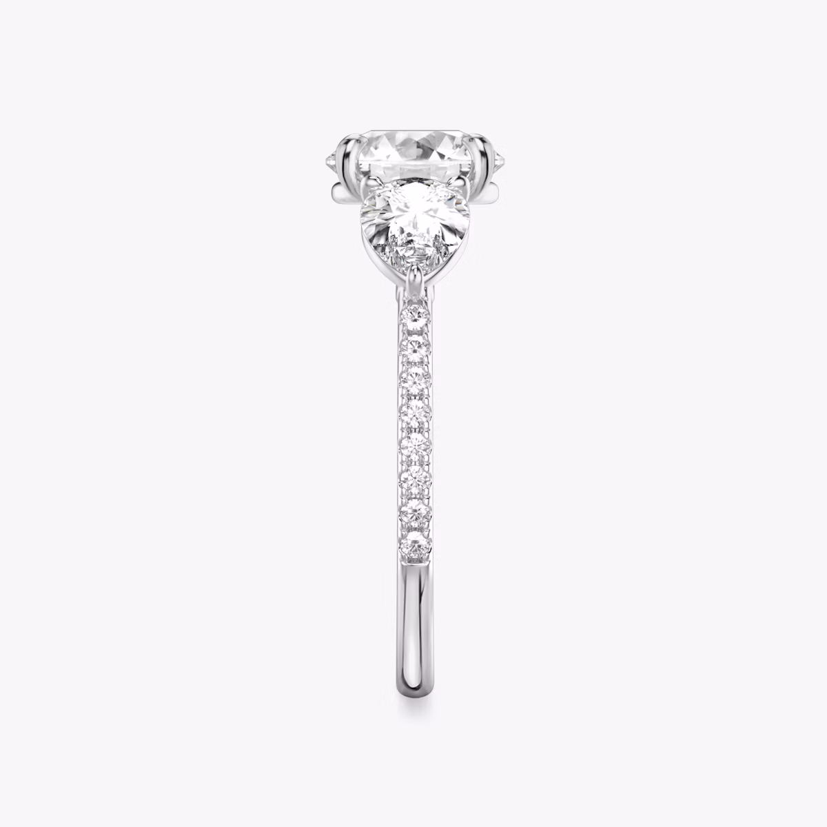 The Three Stone | Round Brilliant | Platinum | bandAccent: Pavé | caratWeight: other | sideStoneCarat: 0.50ct | sideStoneShape: Pear | diamondOrientation: vertical