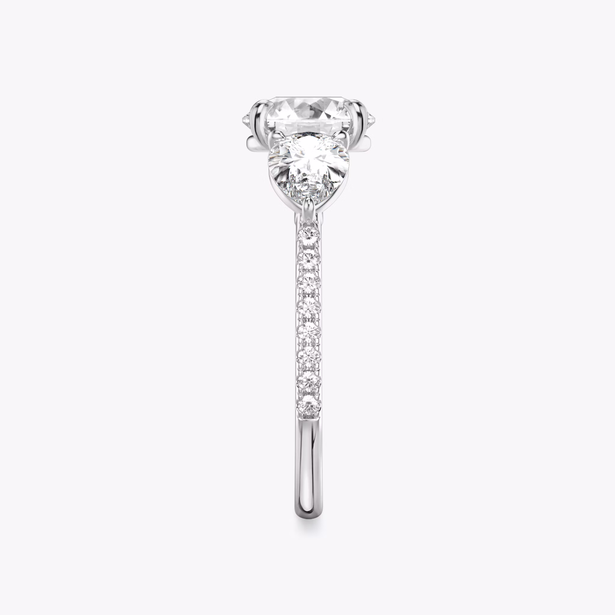 The Three Stone | Round Brilliant | Platinum | bandAccent: Pavé | caratWeight: other | sideStoneCarat: 0.50ct | sideStoneShape: Pear | diamondOrientation: vertical