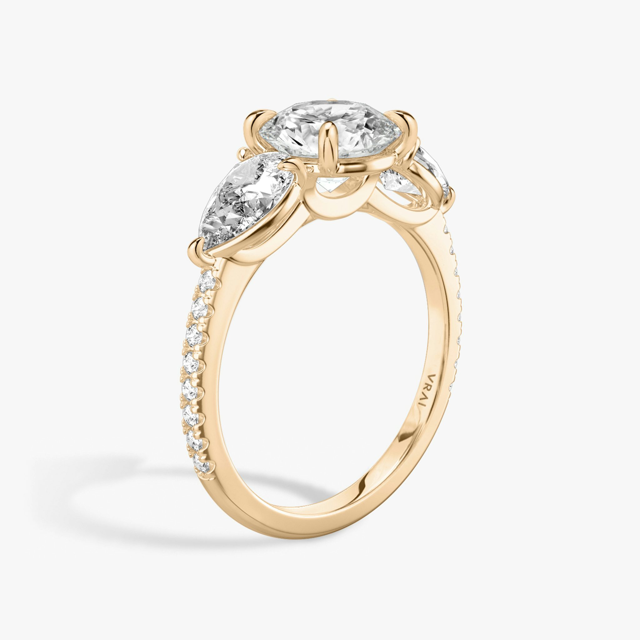 The Three Stone | Round Brilliant | 14k | Rose Gold | bandAccent: Pavé | caratWeight: other | sideStoneCarat: 0.50ct | sideStoneShape: Pear | diamondOrientation: vertical