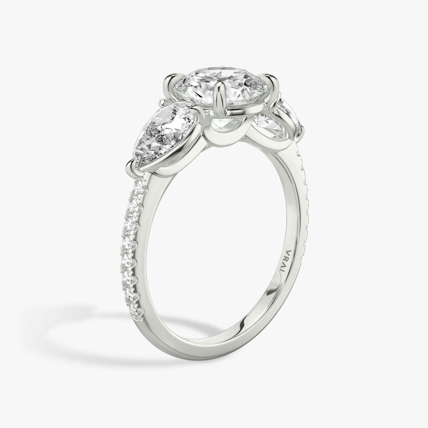 The Three Stone | Round Brilliant | 18k | White Gold | bandAccent: Pavé | caratWeight: other | sideStoneCarat: 0.50ct | sideStoneShape: Pear | diamondOrientation: vertical