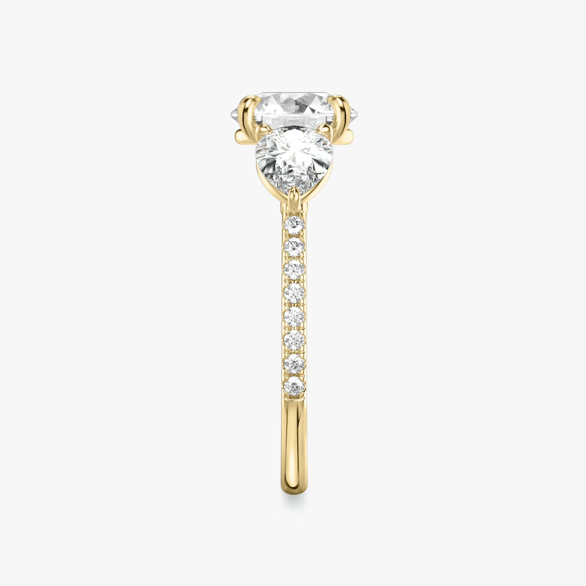 The Three Stone | Round Brilliant | 18k | Yellow Gold | bandAccent: Pavé | caratWeight: other | sideStoneCarat: 0.50ct | sideStoneShape: Pear | diamondOrientation: vertical