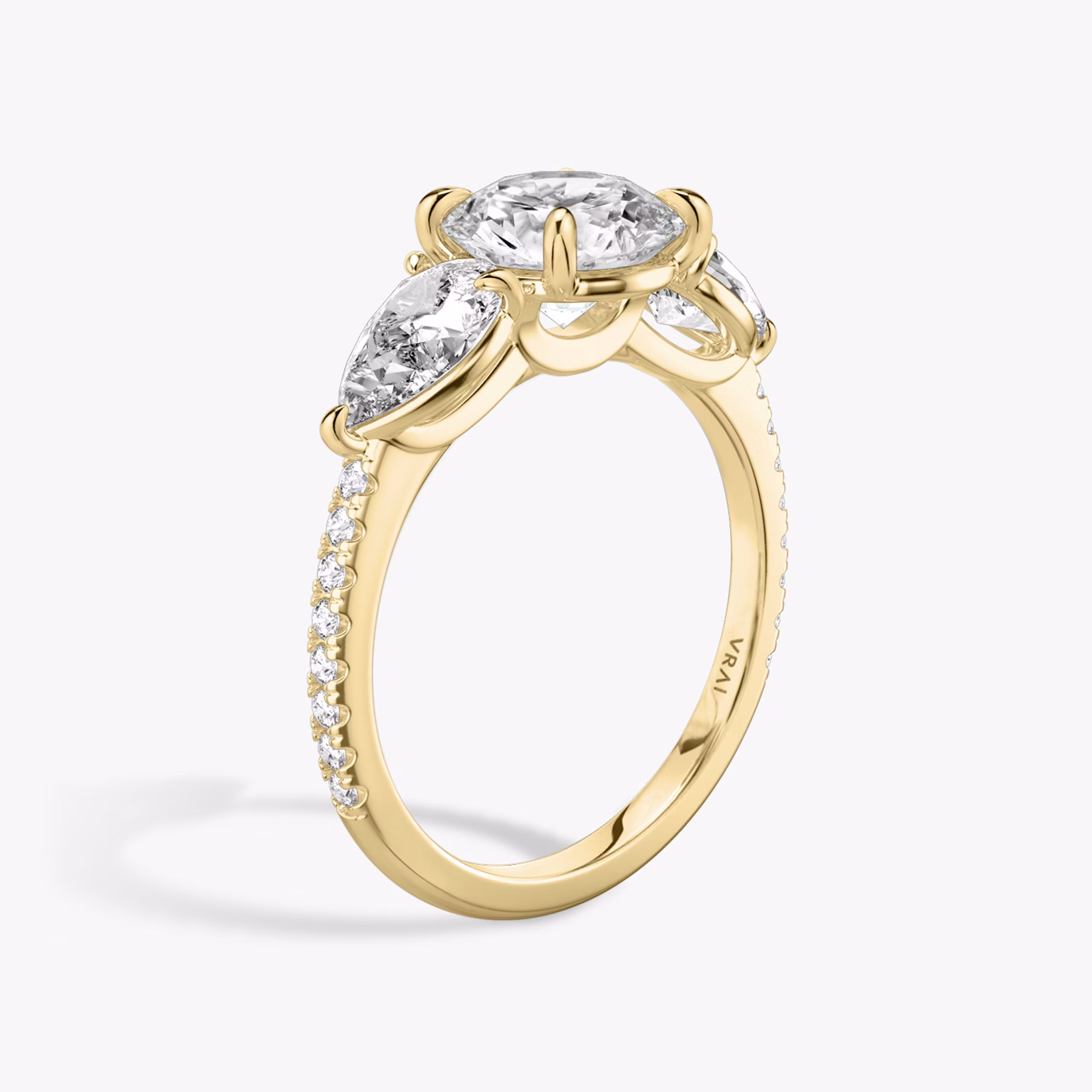 The Three Stone | Round Brilliant | 18k | Yellow Gold | bandAccent: Pavé | caratWeight: other | sideStoneCarat: 0.50ct | sideStoneShape: Pear | diamondOrientation: vertical