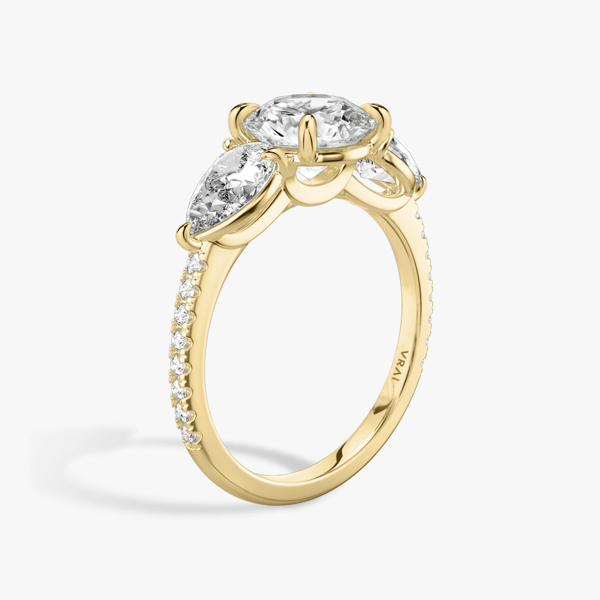 The Three Stone | Round Brilliant | 18k | Yellow Gold | bandAccent: Pavé | caratWeight: other | sideStoneCarat: 0.50ct | sideStoneShape: Pear | diamondOrientation: vertical
