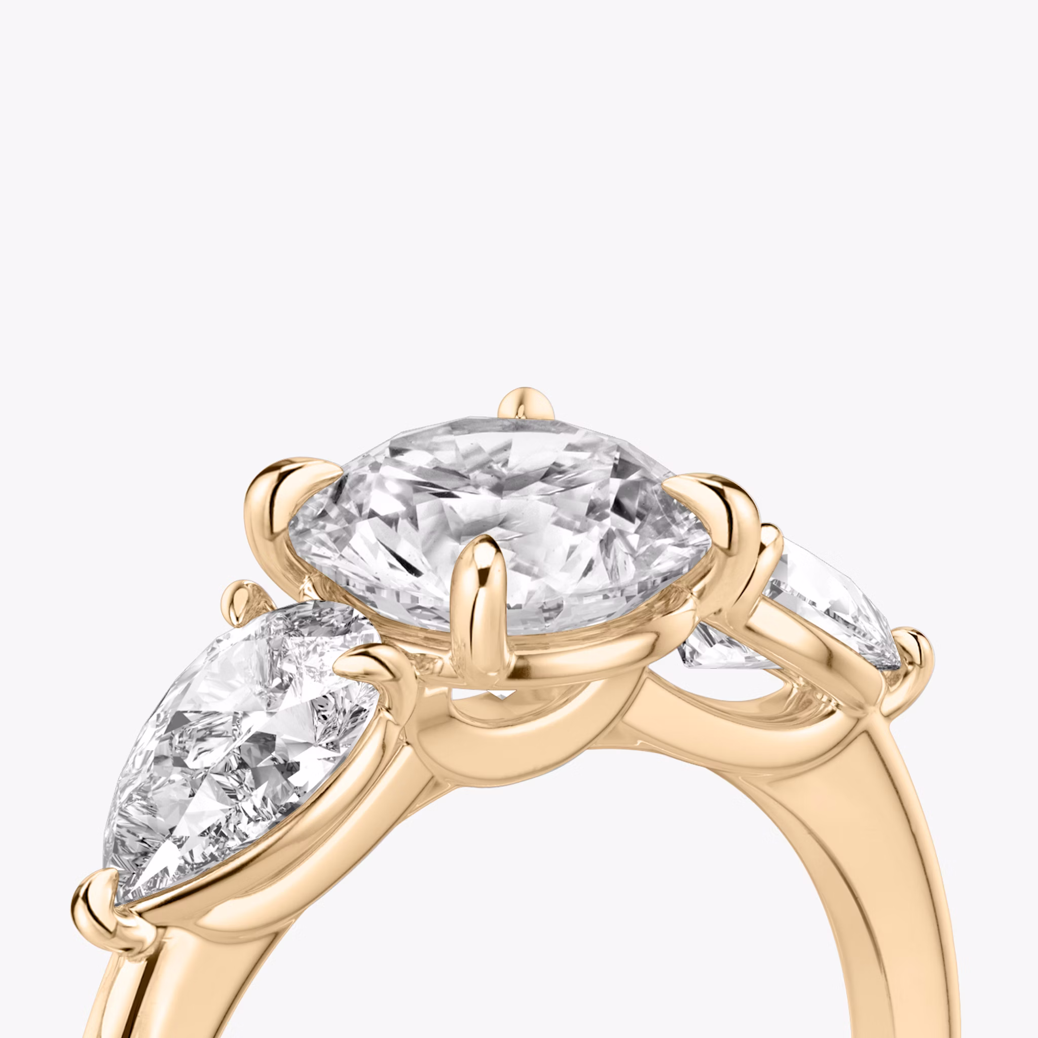 The Three Stone | Round Brilliant | 14k | Rose Gold | bandAccent: Plain | caratWeight: other | sideStoneCarat: 0.50ct | sideStoneShape: Pear | diamondOrientation: vertical